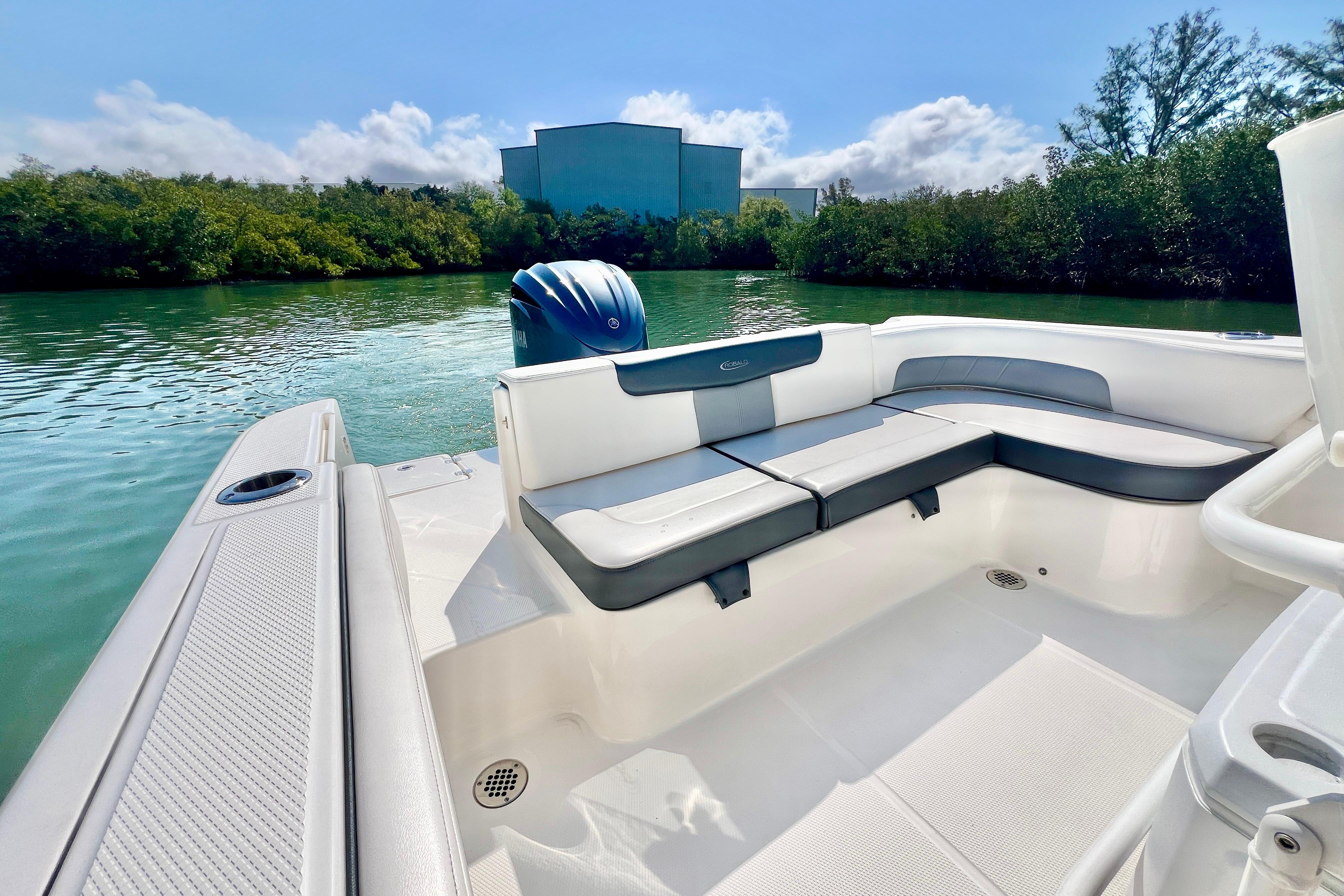 2021 Robalo R242 Explorer boat interior with seating, on a serene waterway.