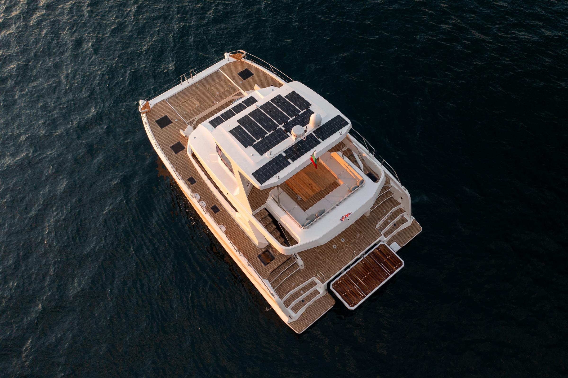 Aerial view of 2025 Custom Omaya 50 Power Catamaran on water.