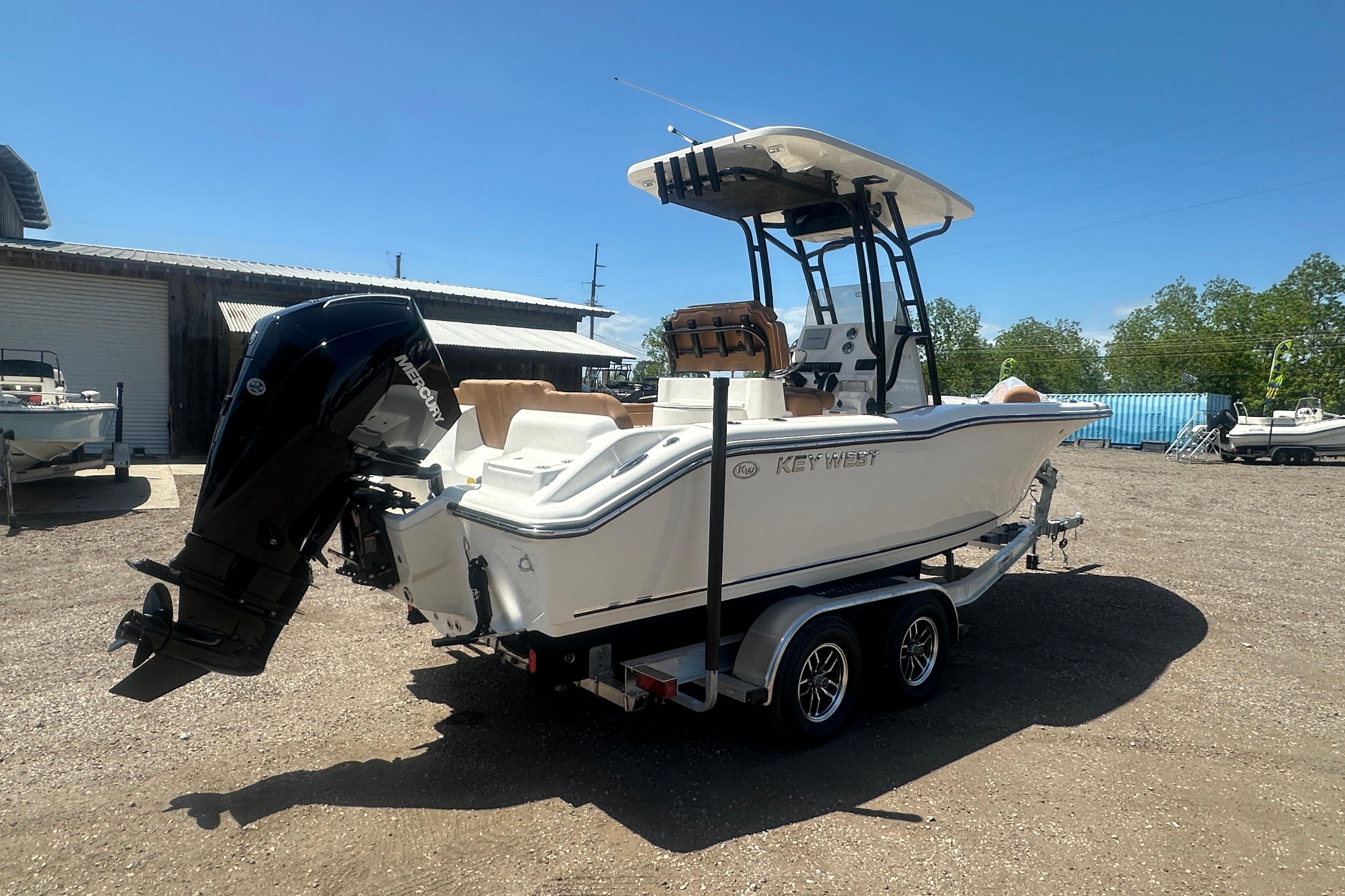 2026 Key West 239 FS boat on trailer, parked outdoors under clear blue sky.