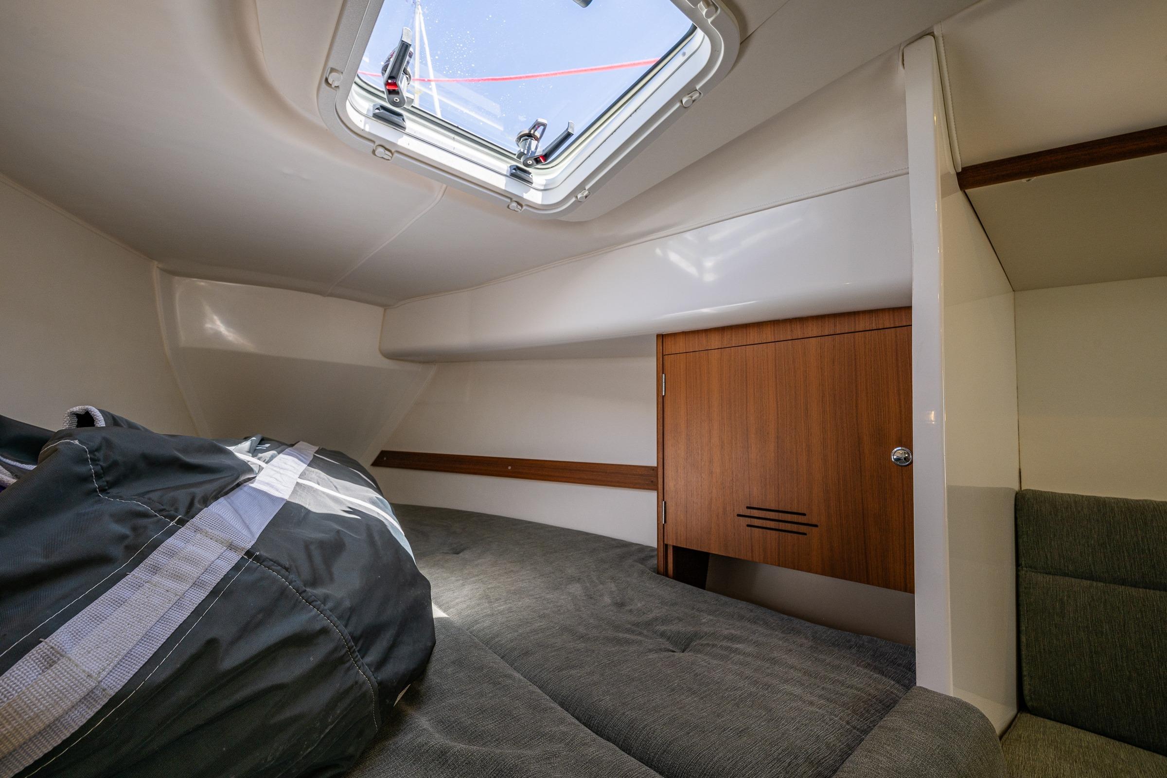Cozy cabin interior of 2018 J Boats J/97E with skylight and wooden storage.