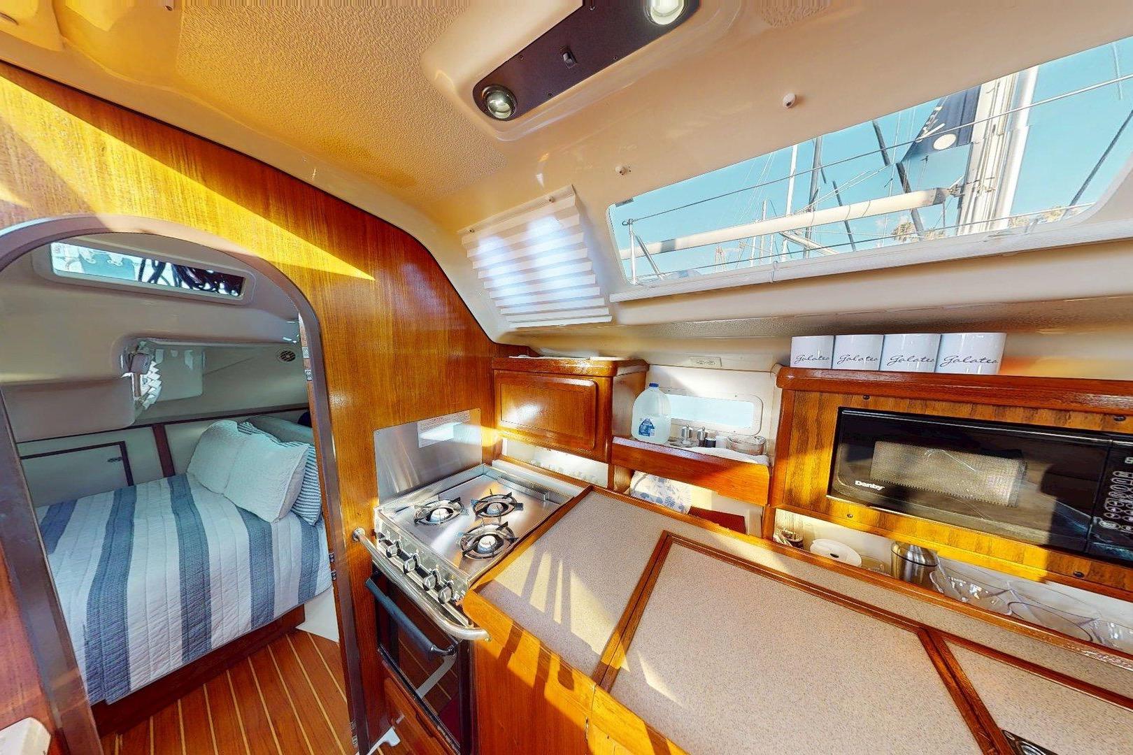 Interior of 1997 Hunter Legend 40.5 sailboat with kitchen and cozy cabin.