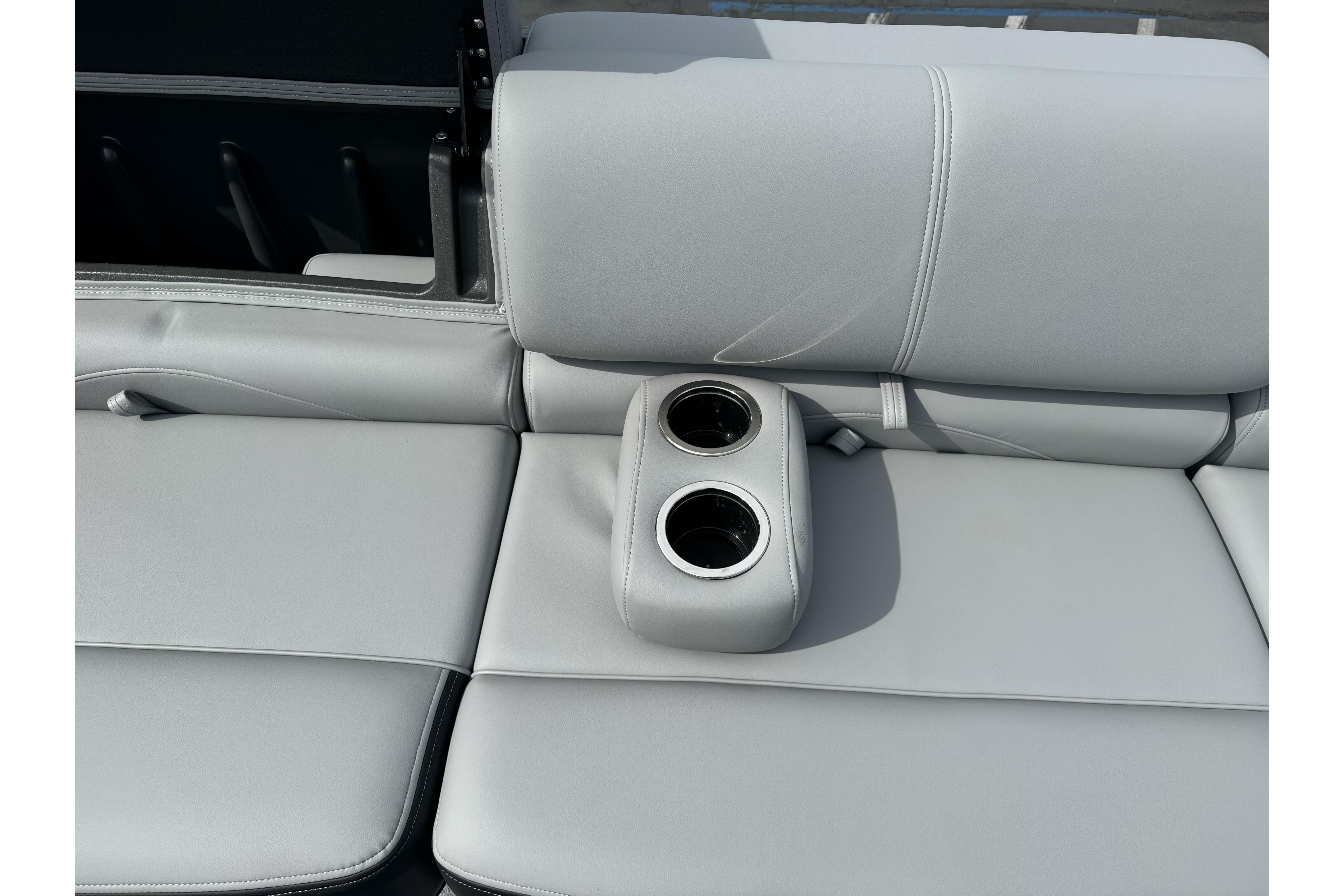 2026 Regency 250 DL boat seat with integrated cup holders, featuring sleek gray upholstery.