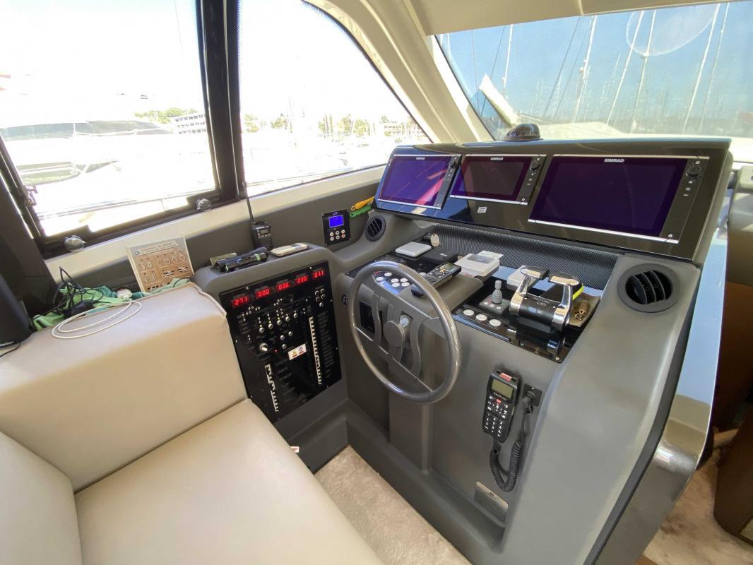 Helm of 2016 Ferretti Yachts 550 with advanced navigation systems and controls.