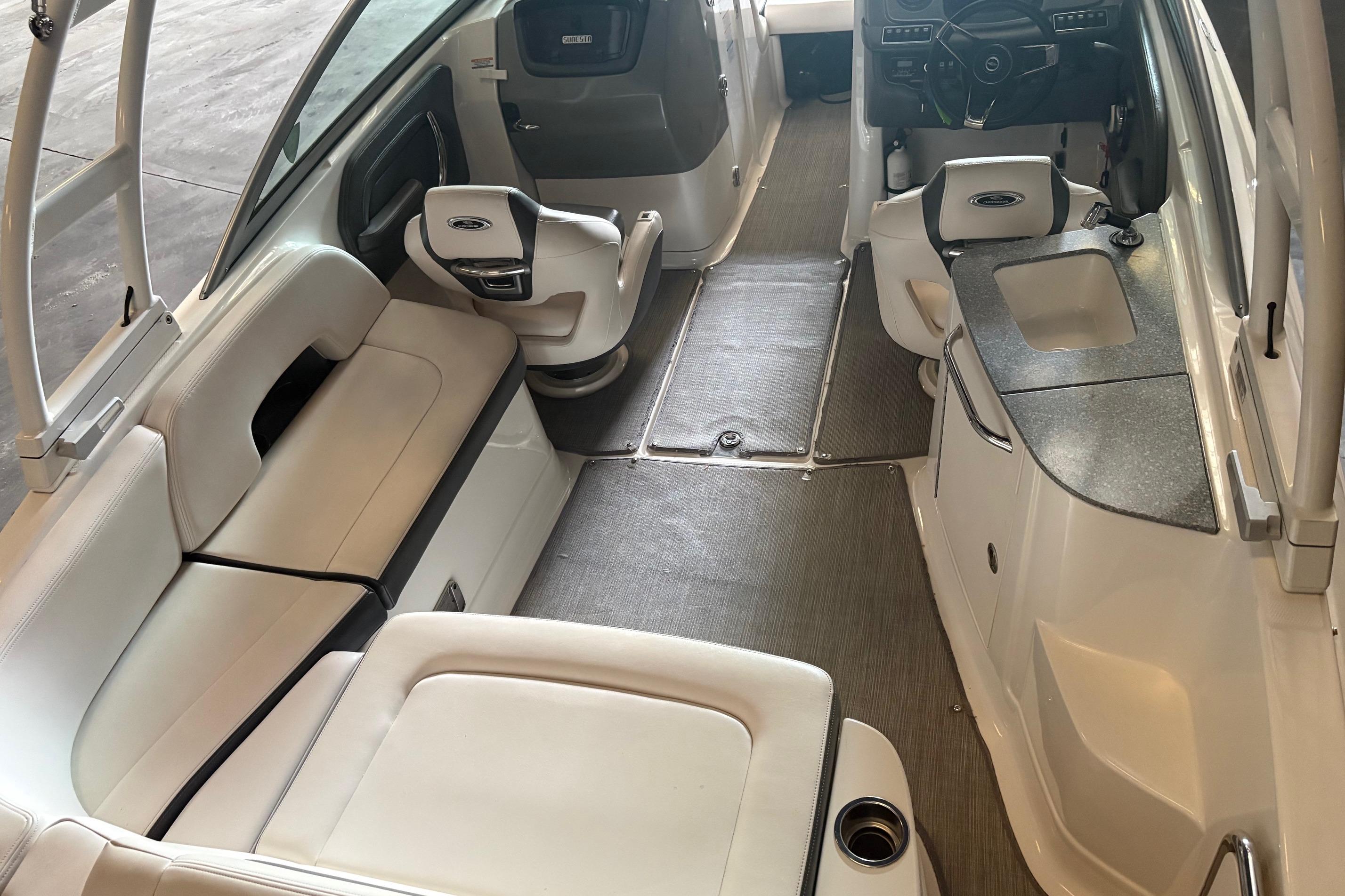 2016 Chaparral 244 Sunesta boat interior with seating, steering, and sink area.