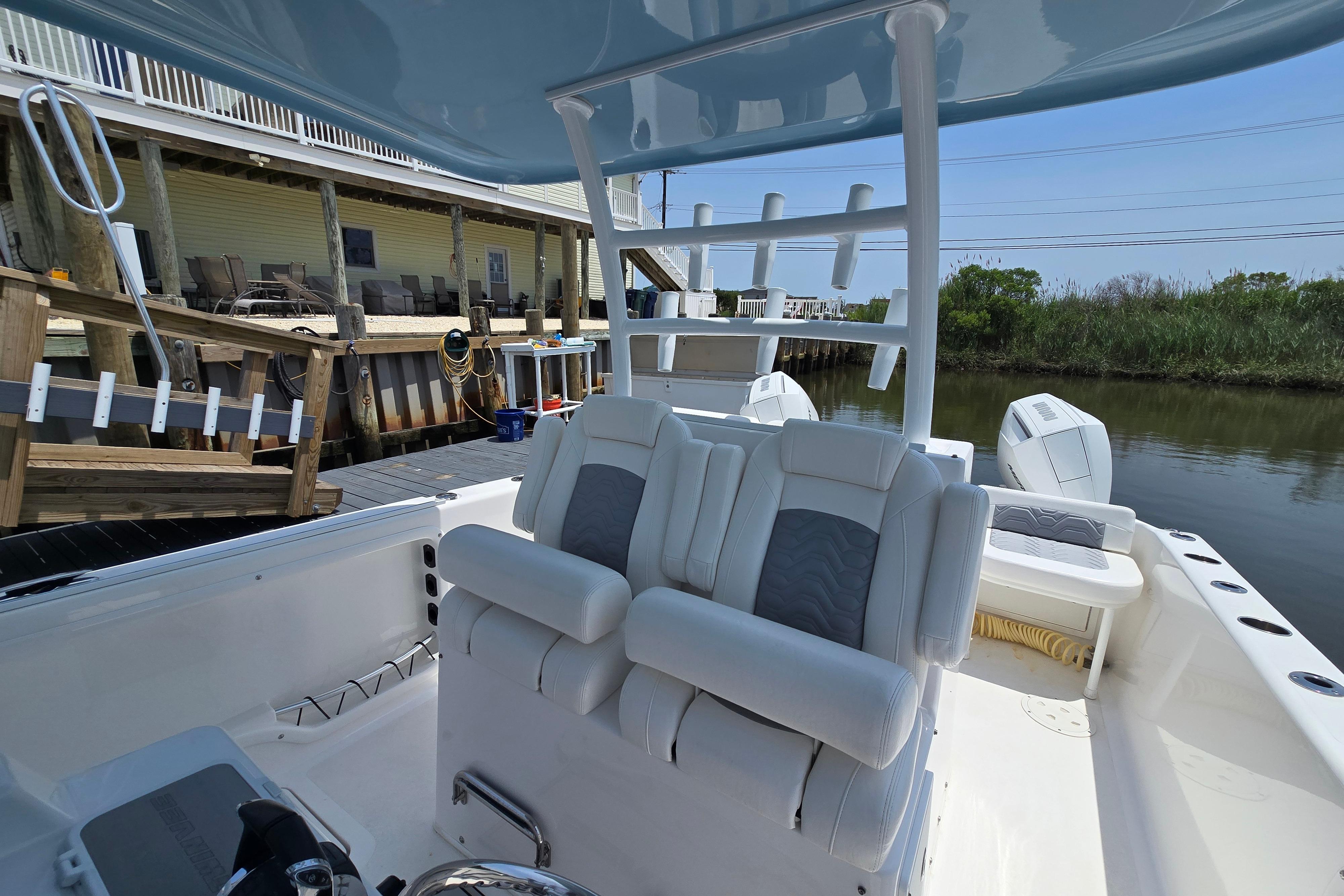 2021 Twin Vee 280 GFX CC boat interior with plush seating and dockside view.