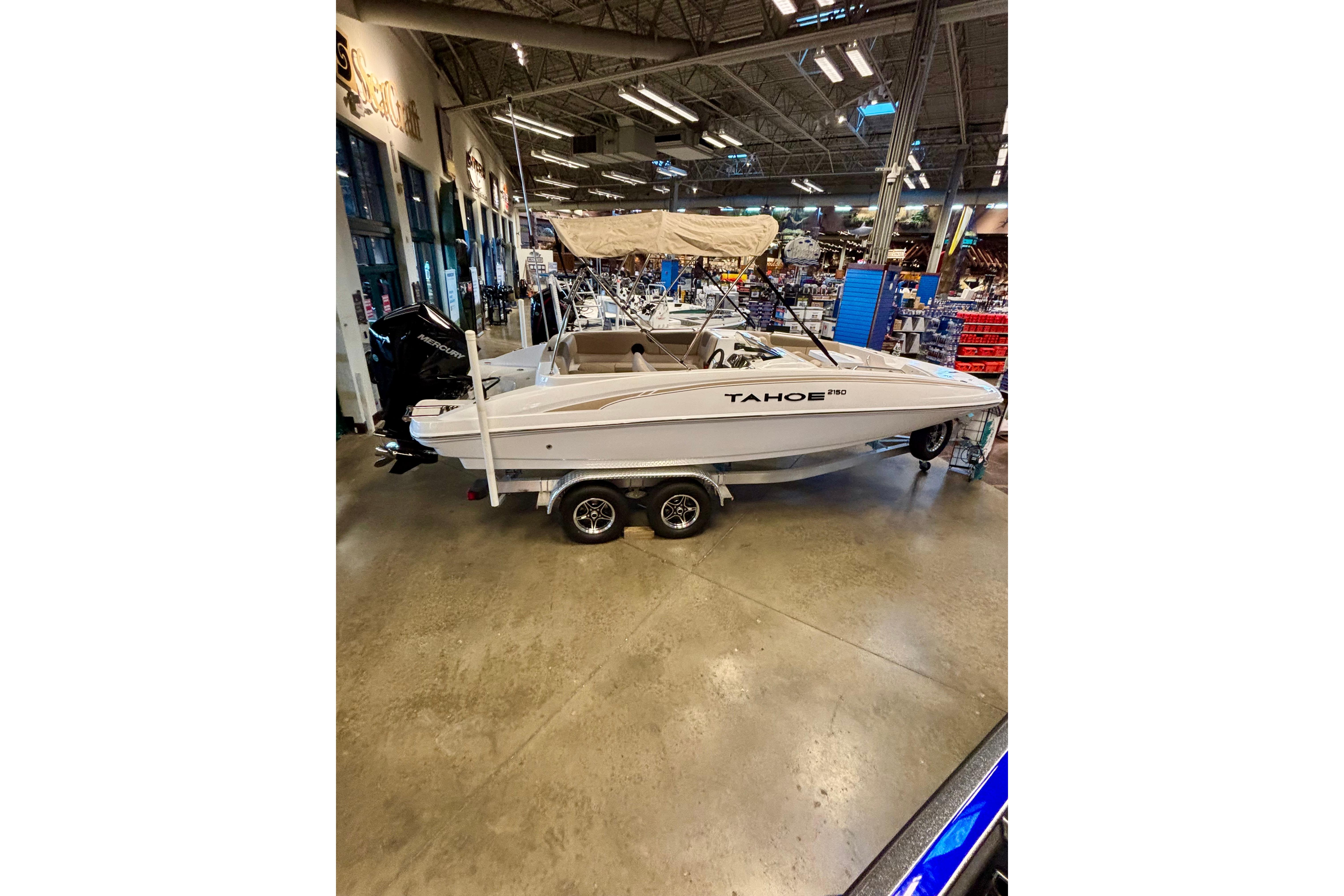 2026 Tahoe 2150 boat displayed indoors on a trailer, featuring a sleek design.