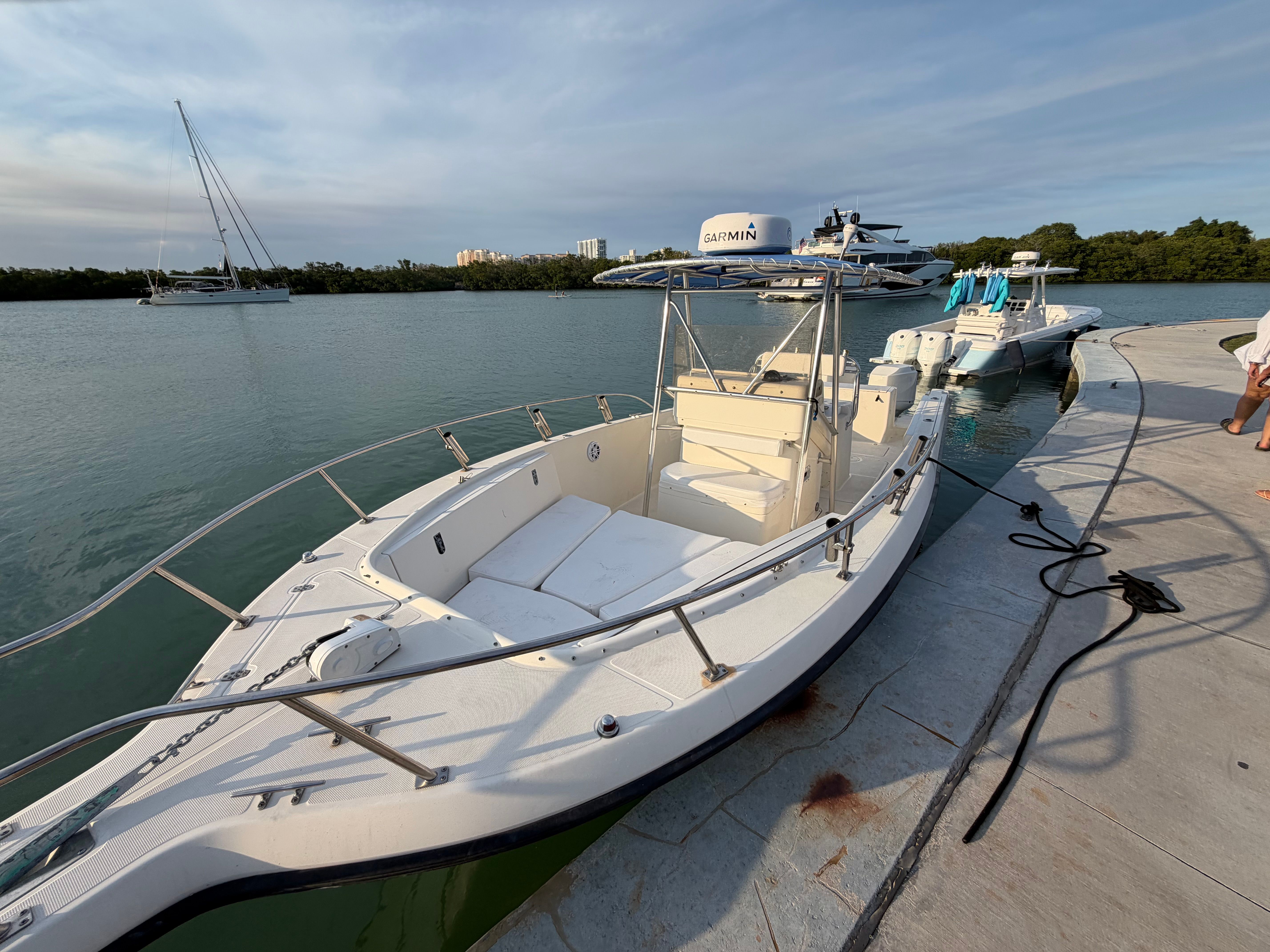 2004 Pursuit 2870 boat docked by calm waters.