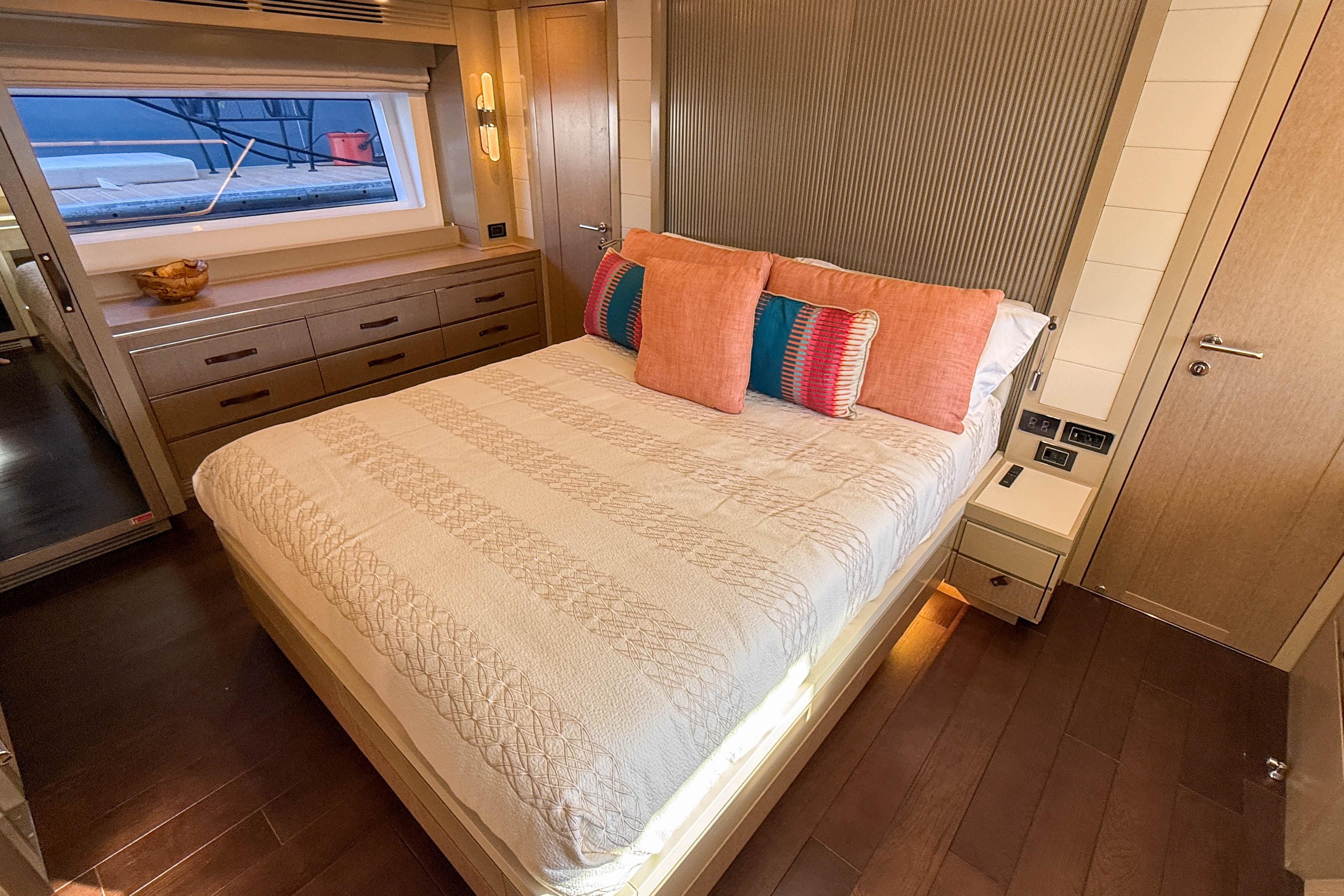 Luxurious bedroom interior of 2023 Sirena 68 yacht with elegant decor and modern furnishings.