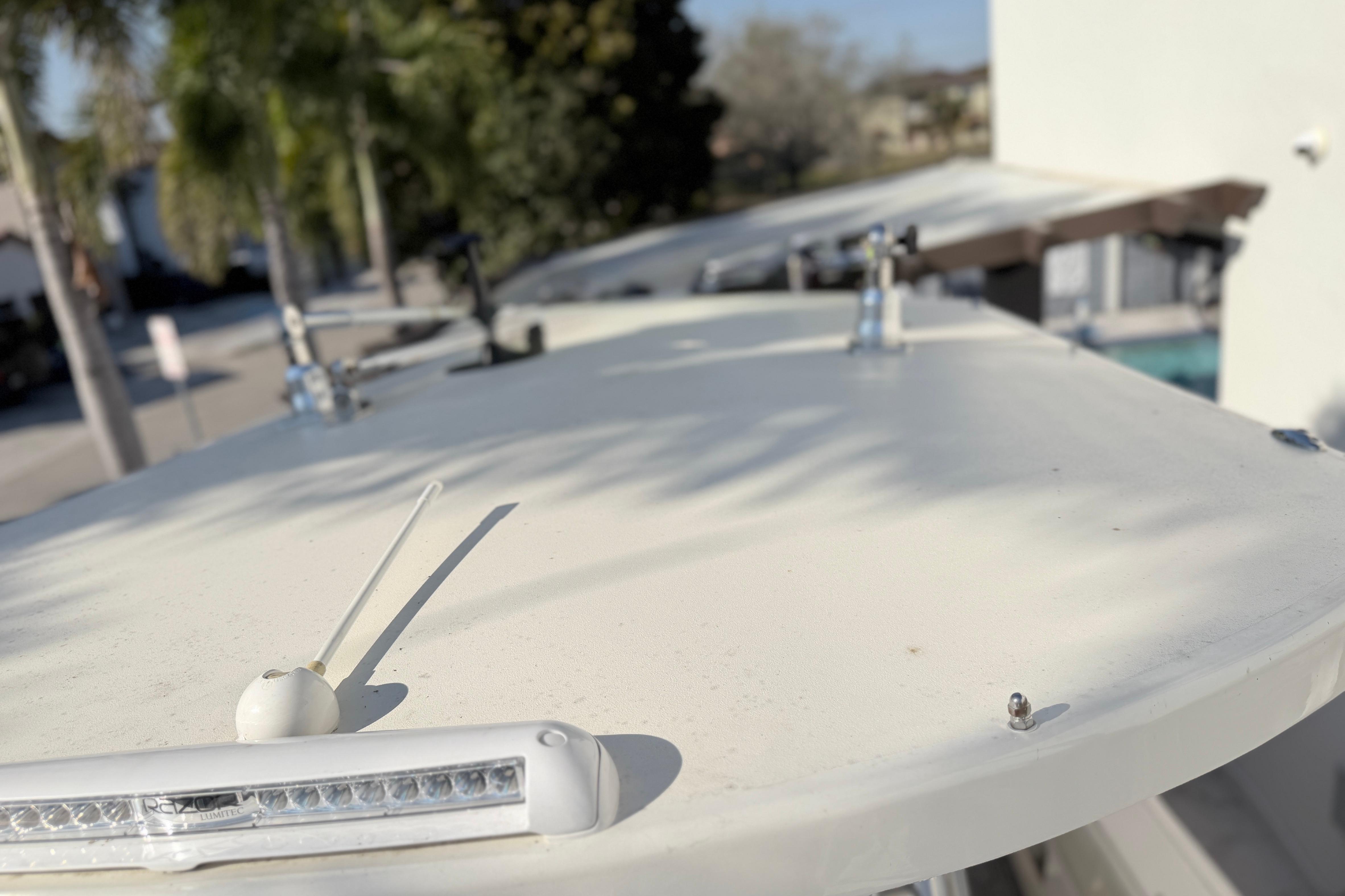 2004 Grady White 273 boat deck with antenna and light, sunny day.
