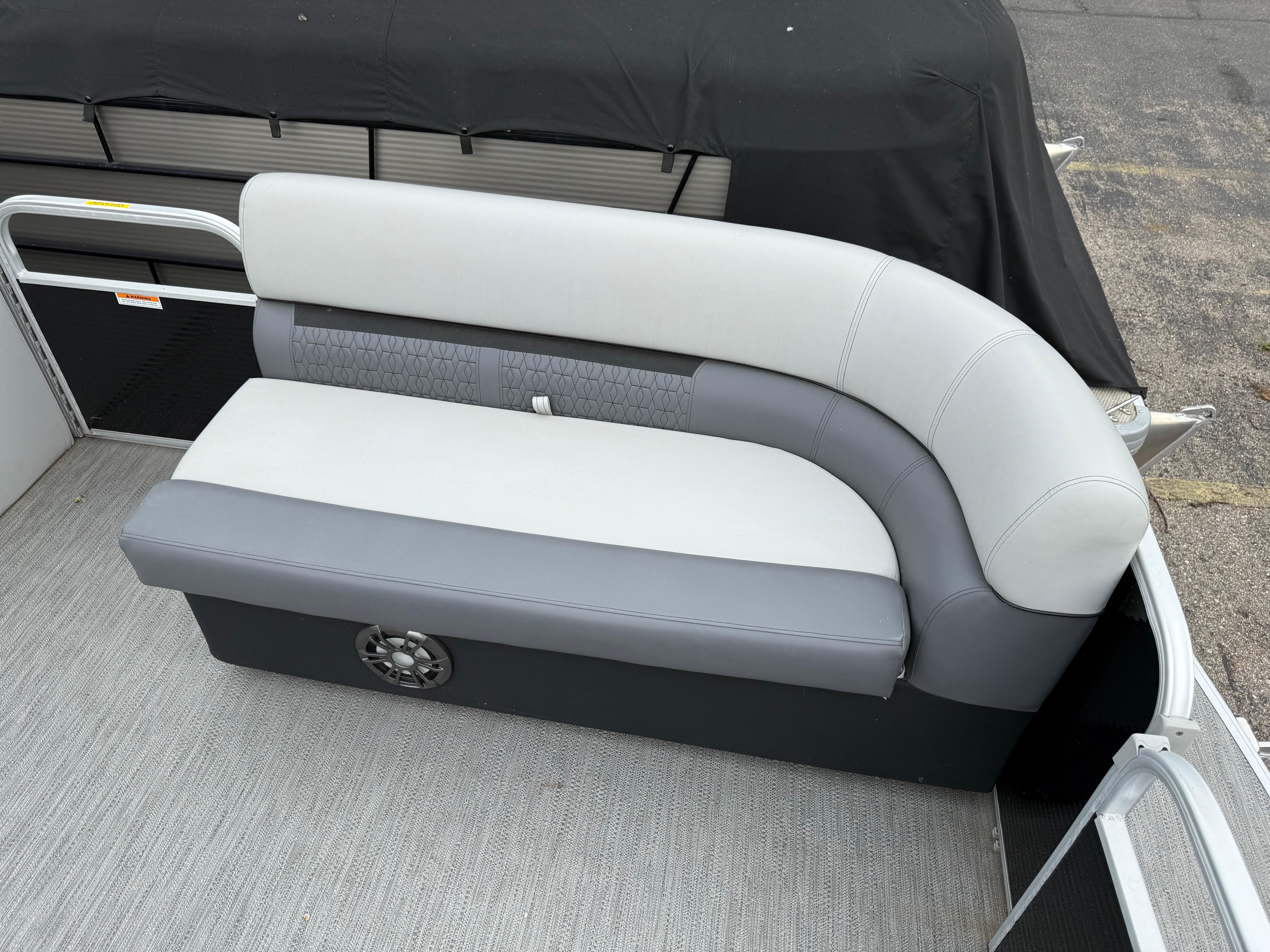 2023 Godfrey Sweetwater boat seating with gray and white upholstery.