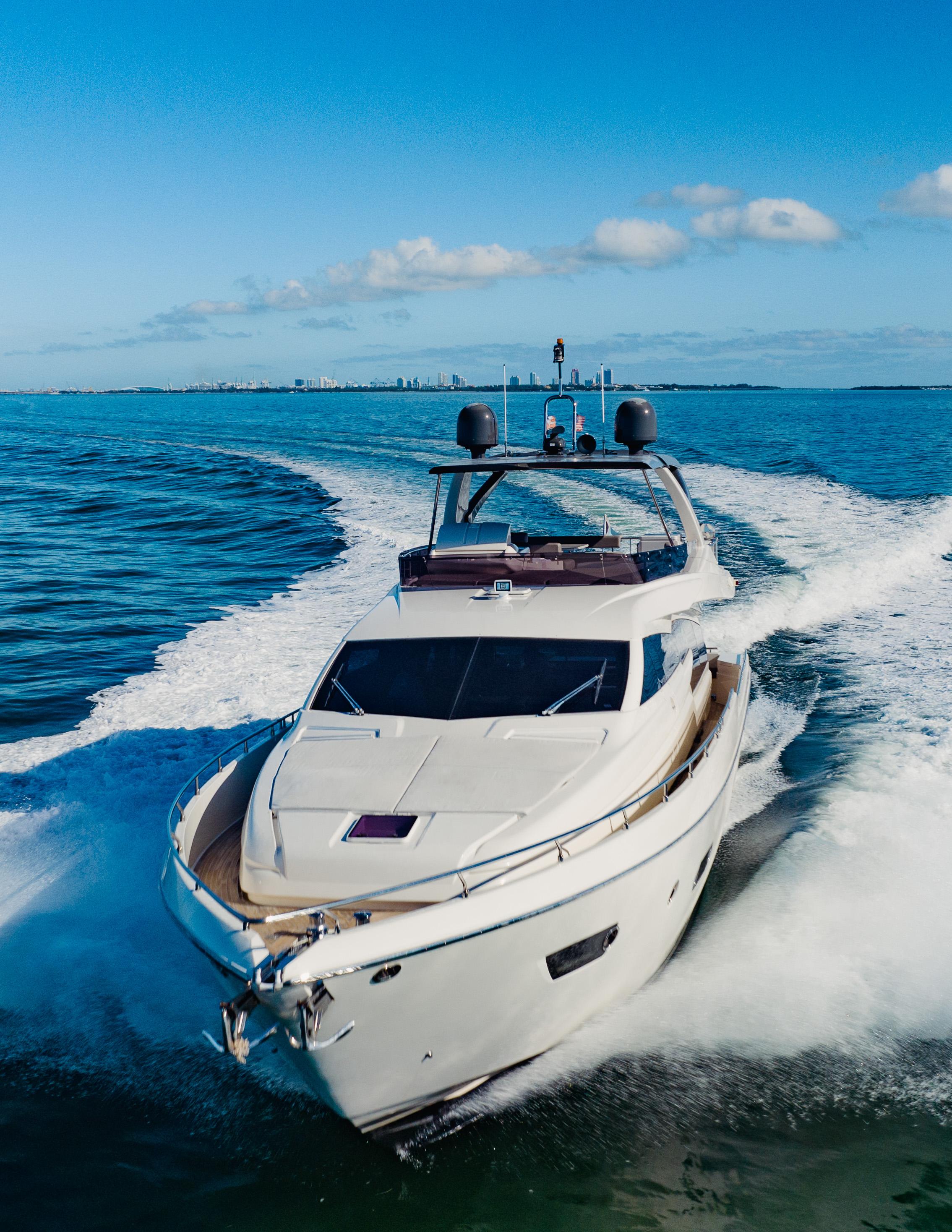 Luxurious 2017 Ferretti Yachts 750 cruising on open water under clear blue skies.