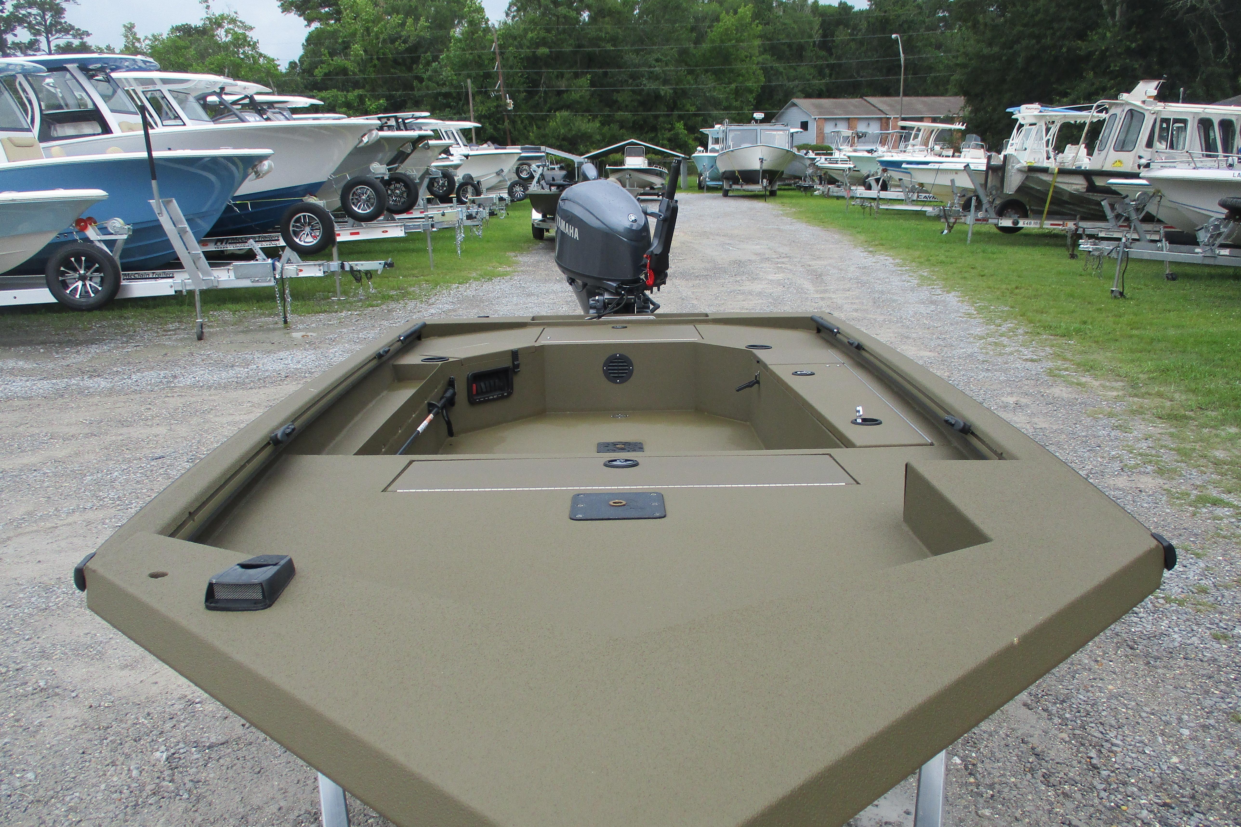 2026 Avid 16 Commander boat displayed at a dealership, surrounded by other boats.