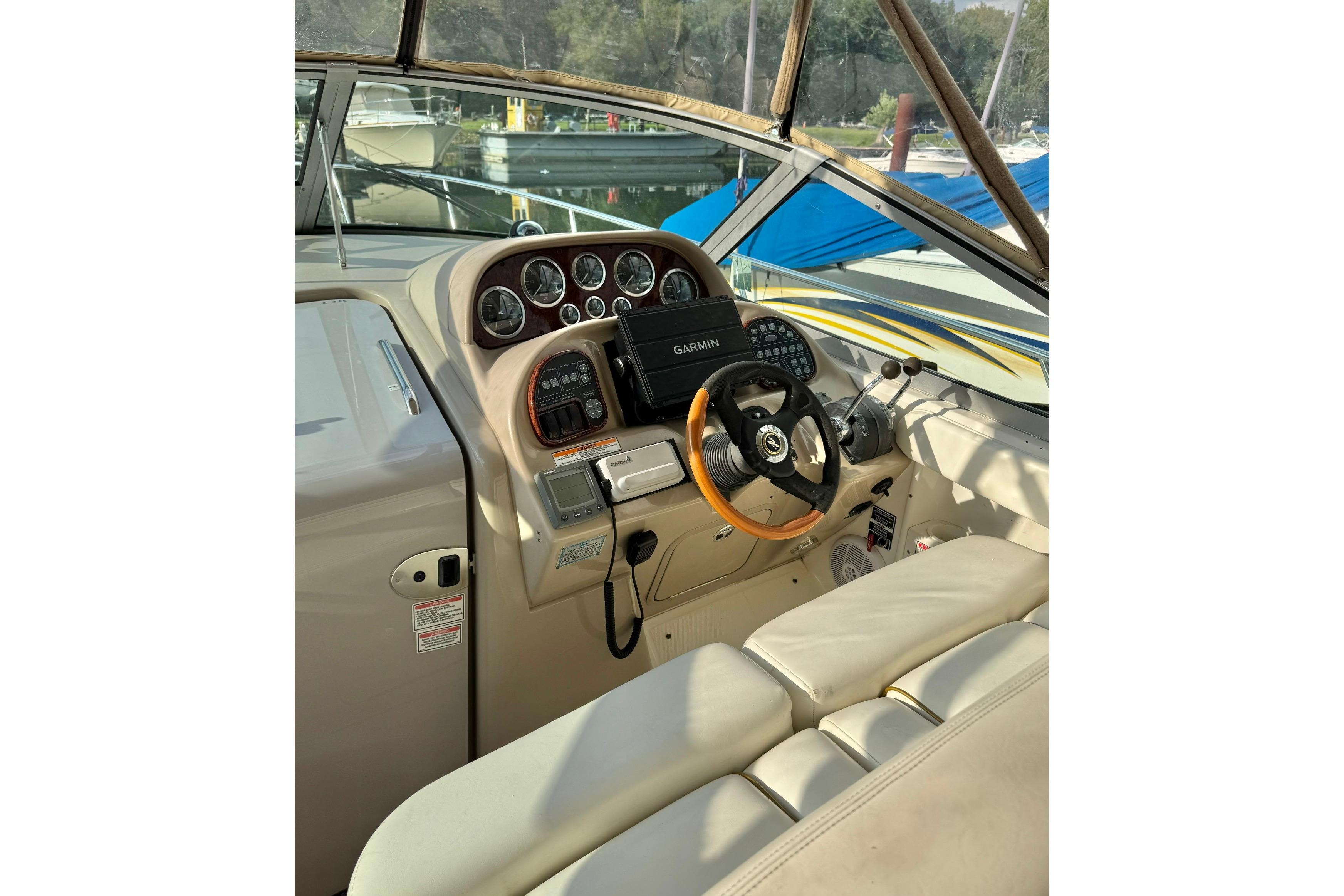 Helm of 2003 Sea Ray 300 Sundancer with Garmin navigation system and leather steering wheel.