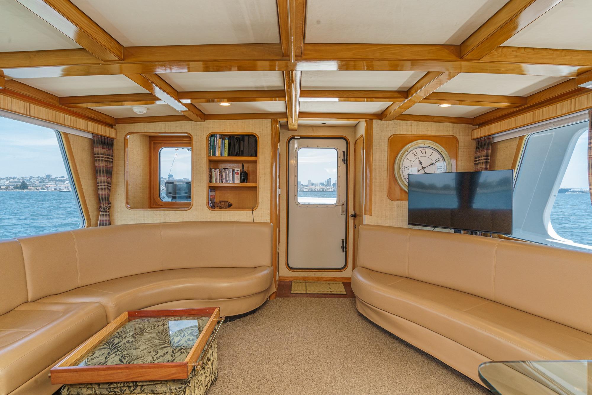 Luxurious interior of a 1990 Seaton Long Range Cruiser with elegant wood accents and plush seating.