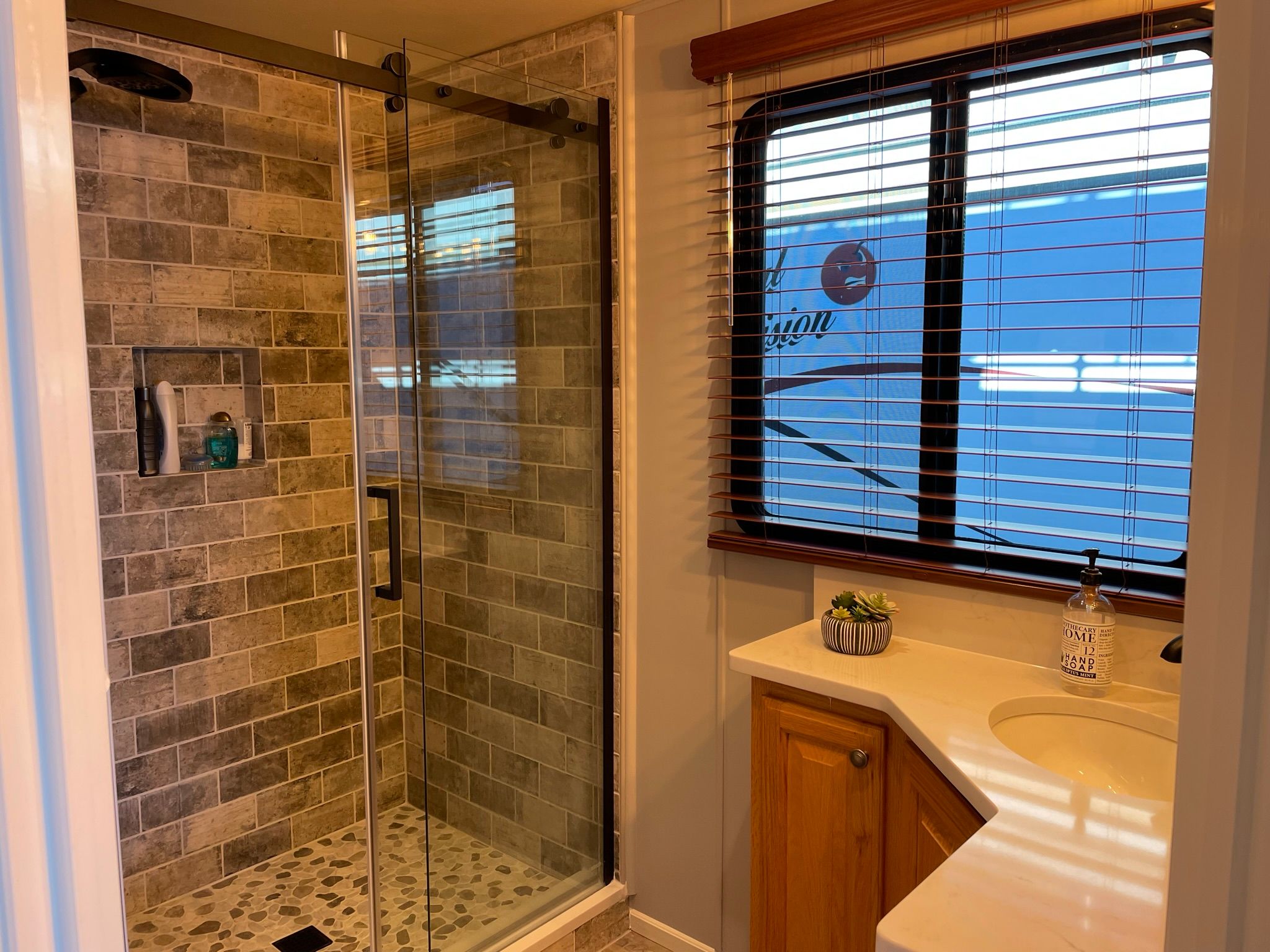 Bathroom in a 2001 Sumerset houseboat with modern shower.
