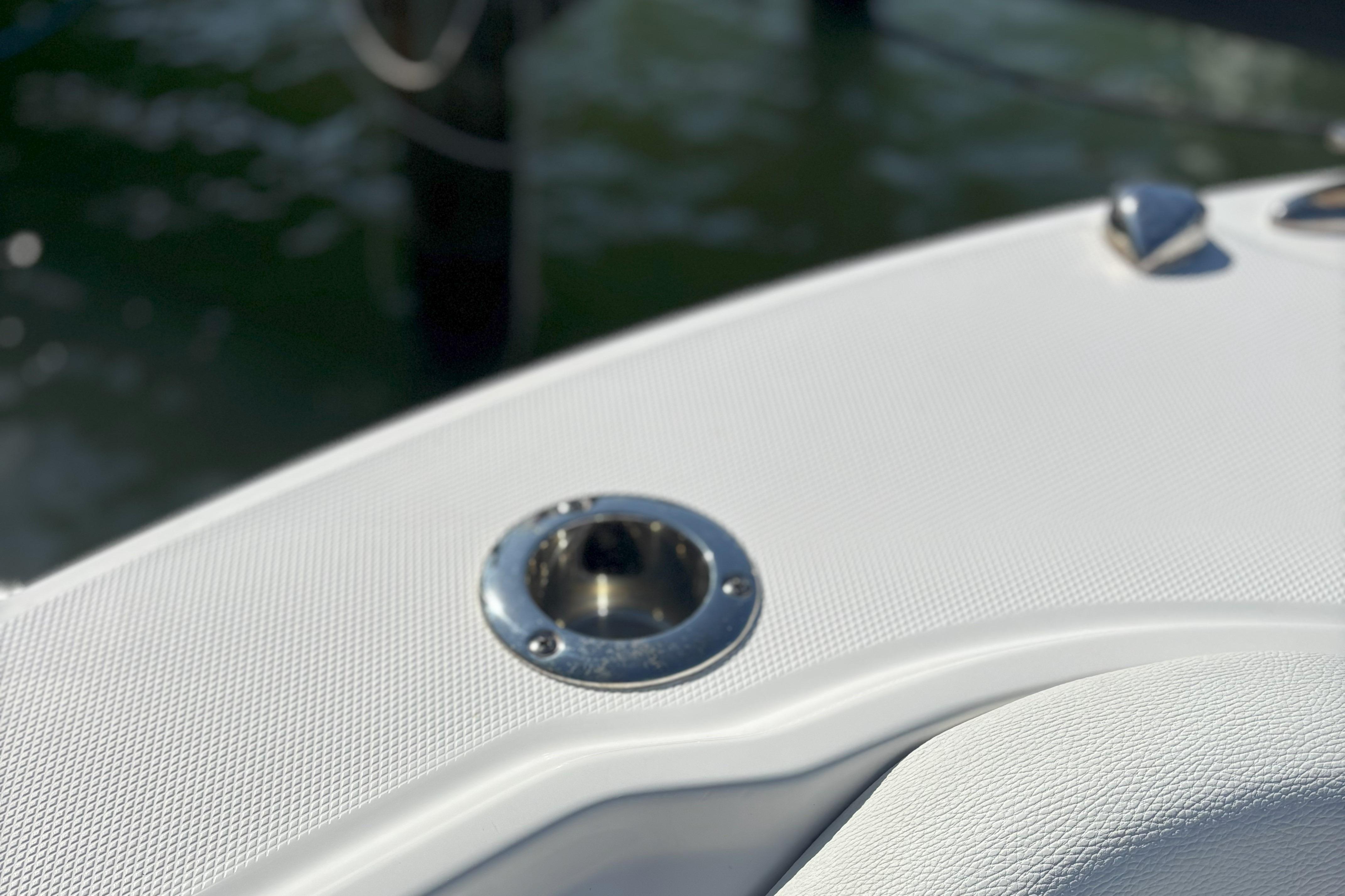 Close-up of 2024 Edgewater 262CC boat deck with metal fixture.