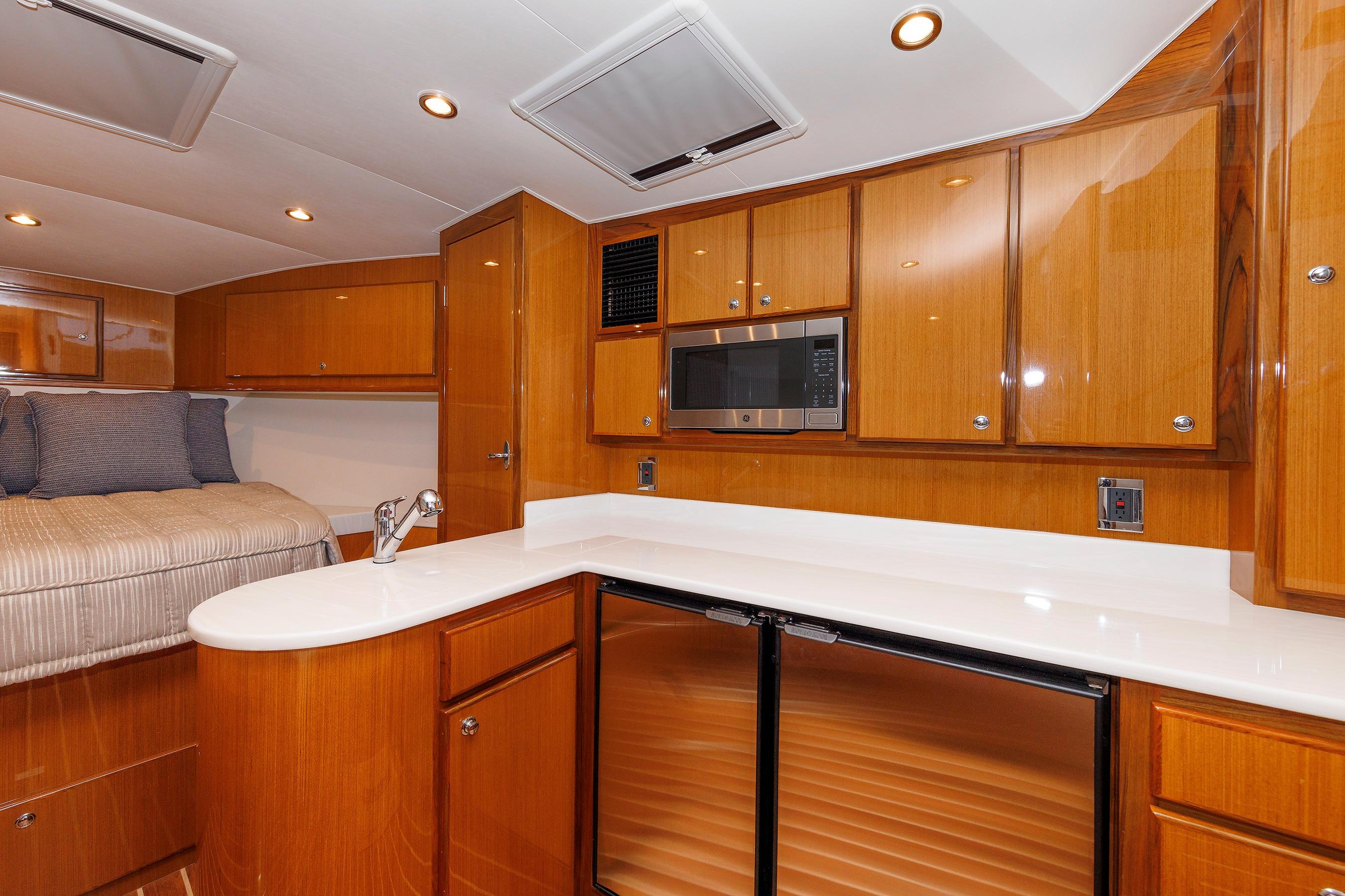 Luxurious interior of 2023 Henriques 42 Express Hardtop yacht with modern kitchen amenities.