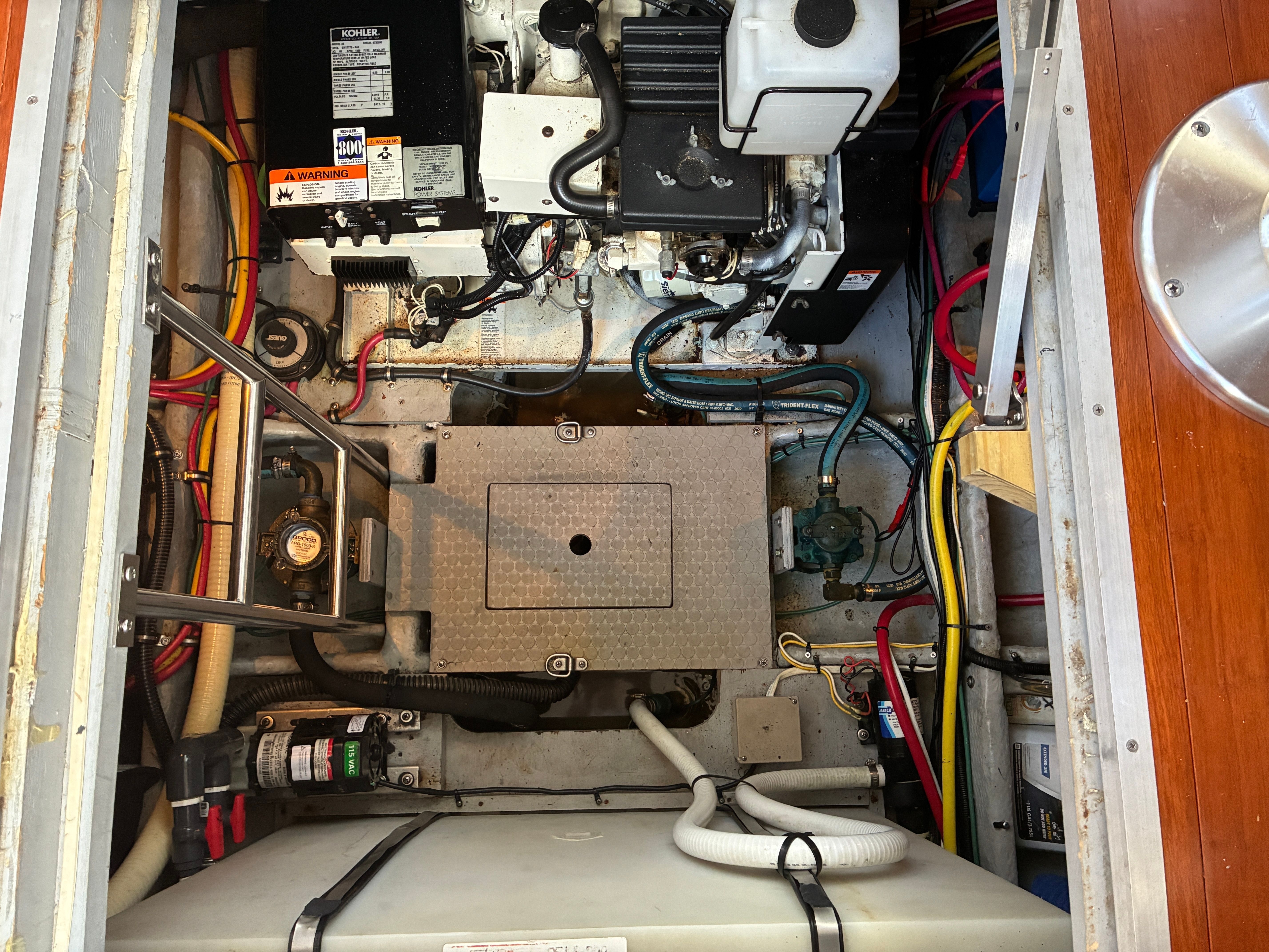 Engine room of the 2001 Silverton 392 Motor Yacht with various cables and equipment.