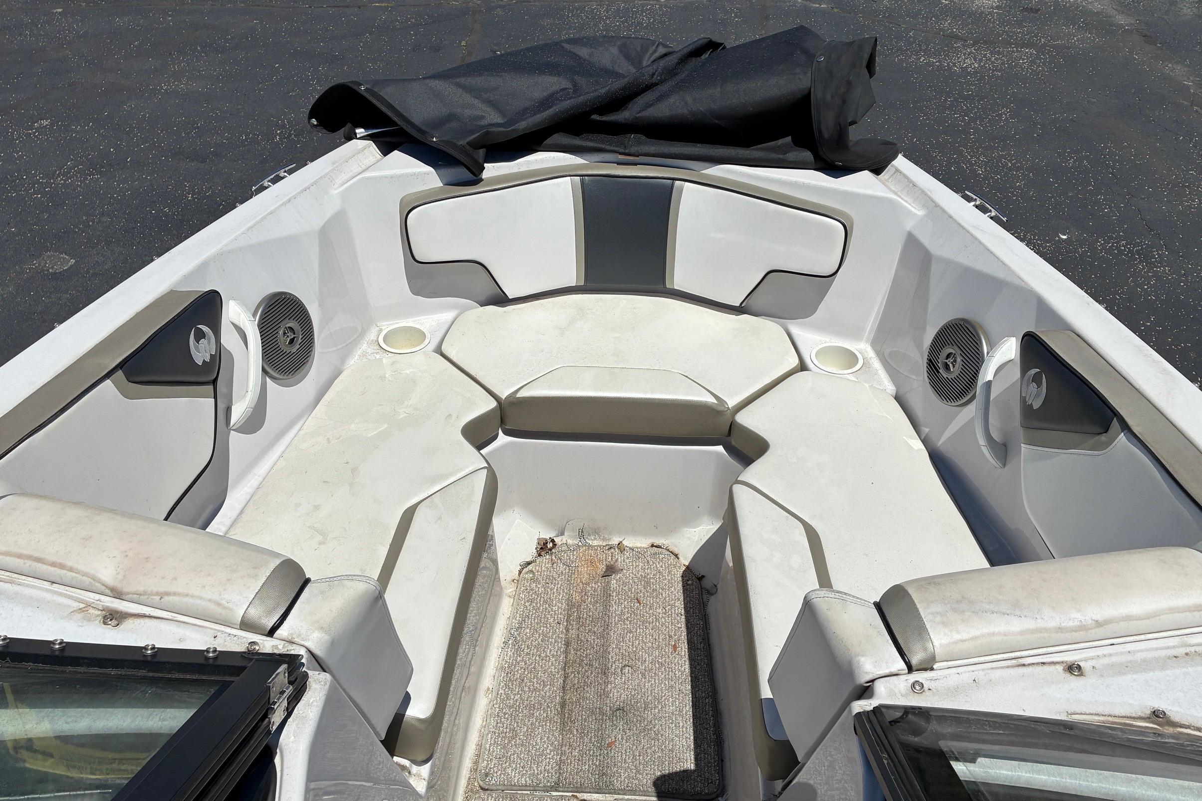 2014 Scarab 215 boat interior with seating and speakers, featuring a clean, spacious design.