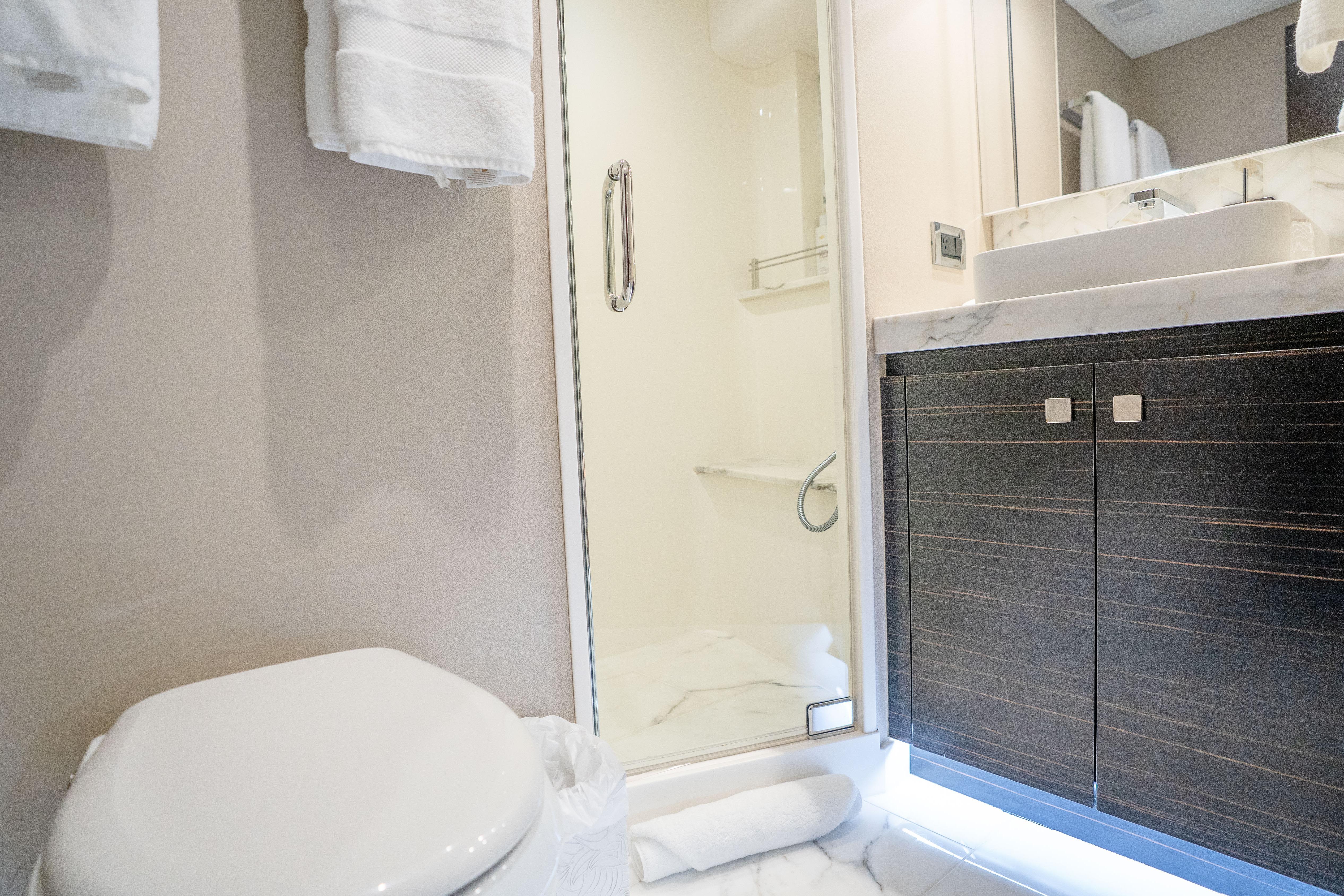 Luxurious bathroom in 2021 Hatteras M75 Panacera yacht with modern fixtures and elegant design.
