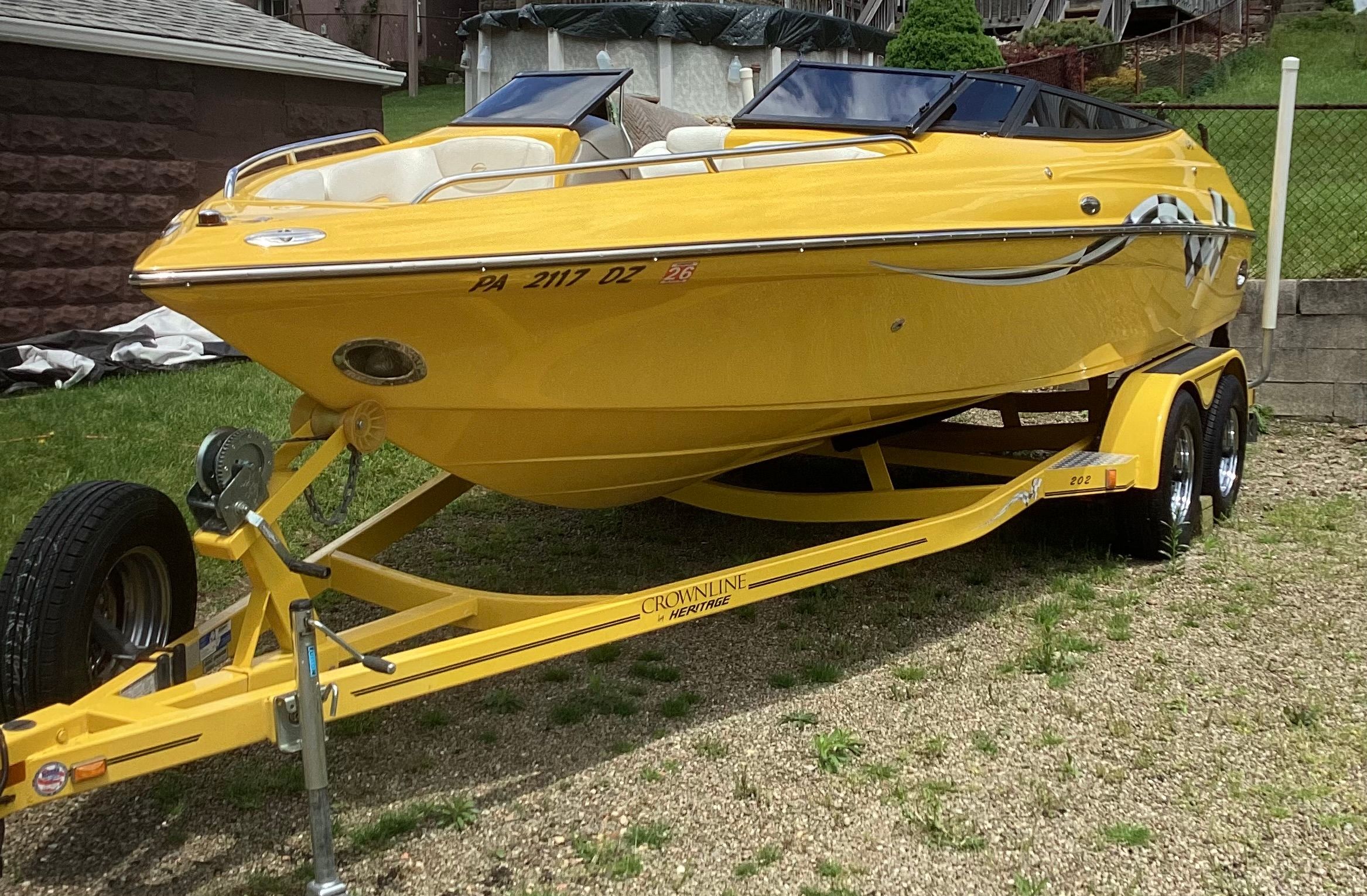 Yellow 2005 Crownline 202 BR LPX boat on trailer.