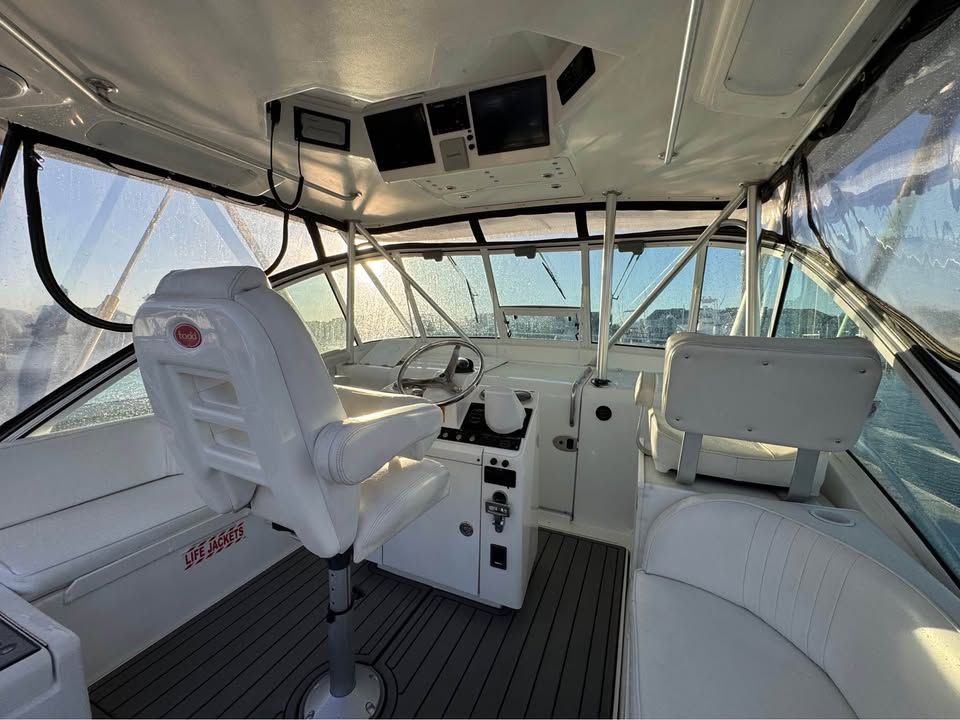 Interior of a 2005 Luhrs 32 Open with white seating and helm console.