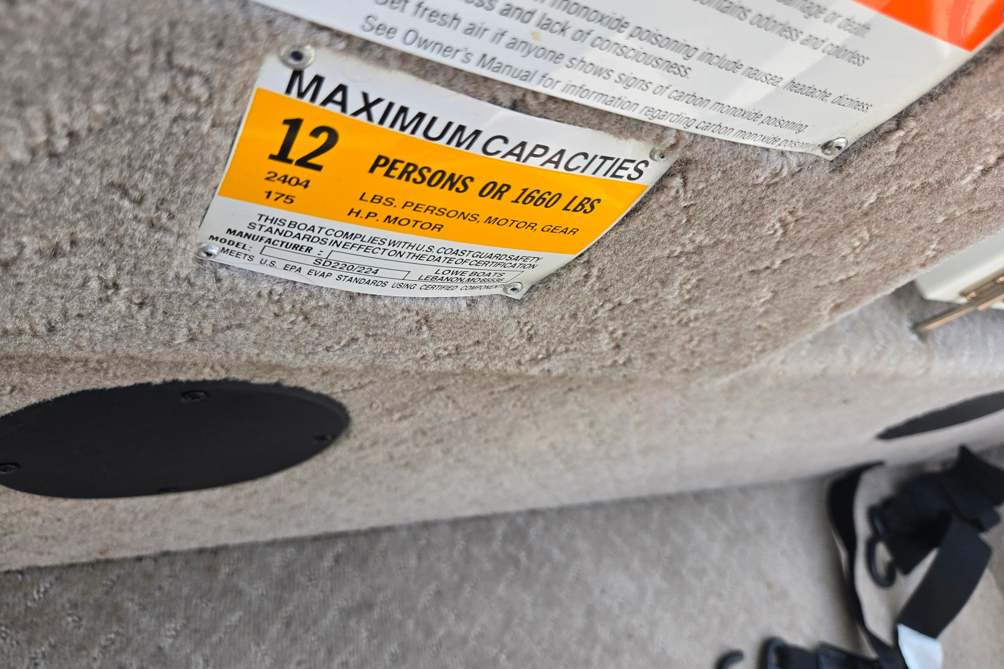 Capacity label on 2015 Lowe Sport Deck 224, indicating 12 persons or 1660 lbs limit.
