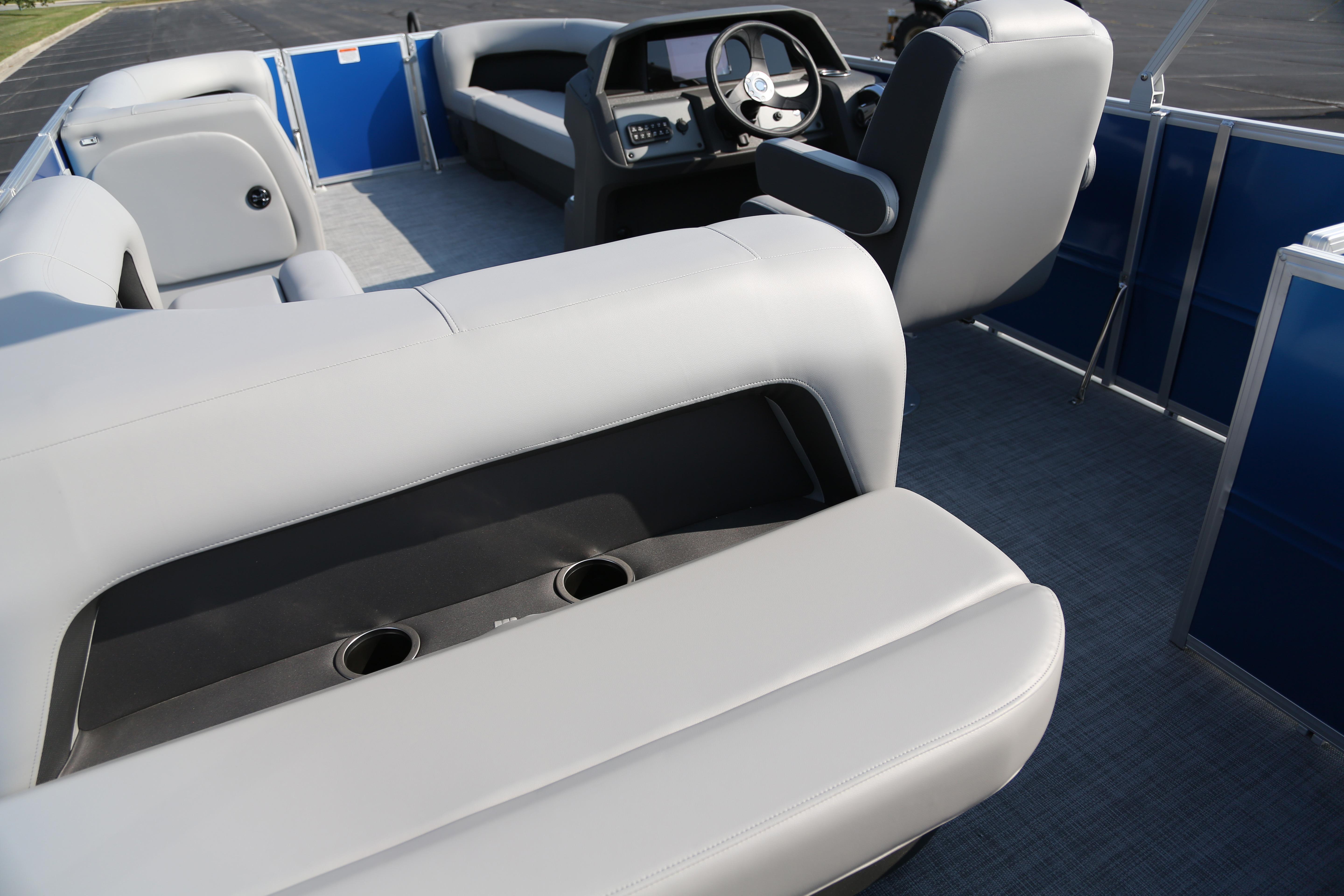 2026 Sun Tracker Party Barge 18 DLX interior with plush seating and modern helm.