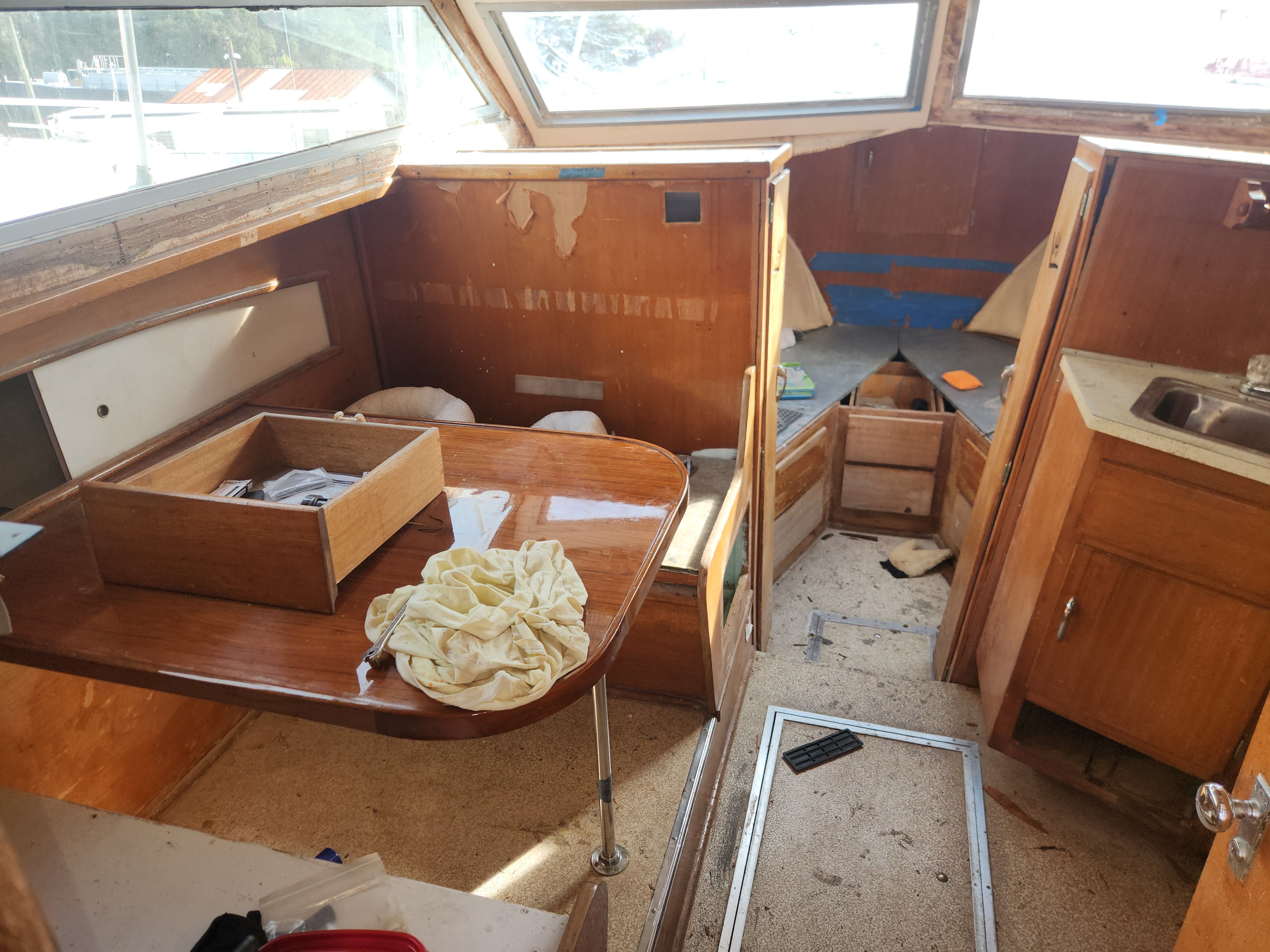 Interior of a 1967 Hatteras 28ft yacht, showing wear and renovation needs.