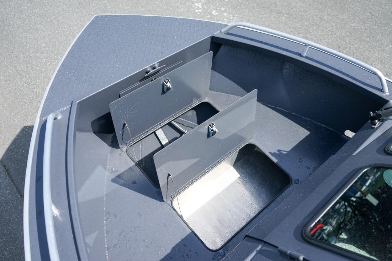 2026 Alumaweld X202 Stryker boat storage compartments, open and empty, on a sunny day.