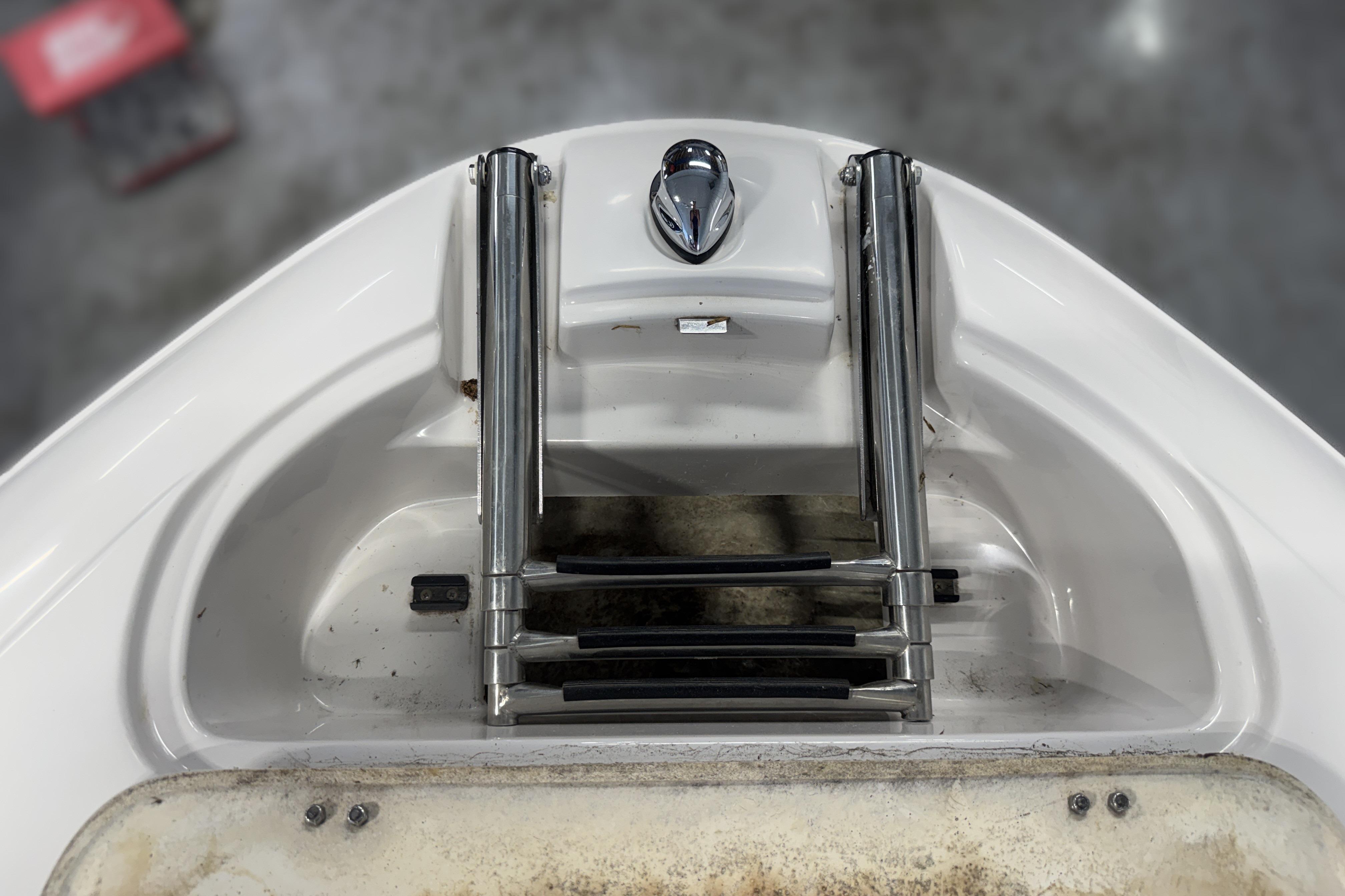 2008 Four Winns H240 boat ladder and handle detail, showcasing stainless steel construction.