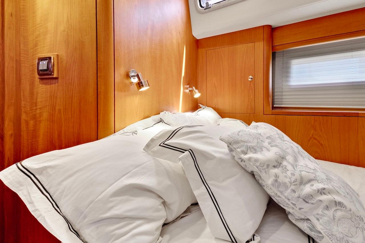 Luxurious cabin interior of 2011 Southerly 57 RS yacht with plush bedding.