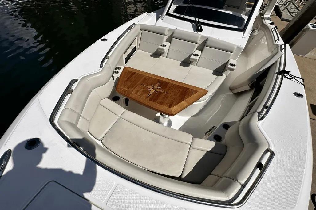 2019 Boston Whaler 350 Realm boat with luxurious seating and wooden table.