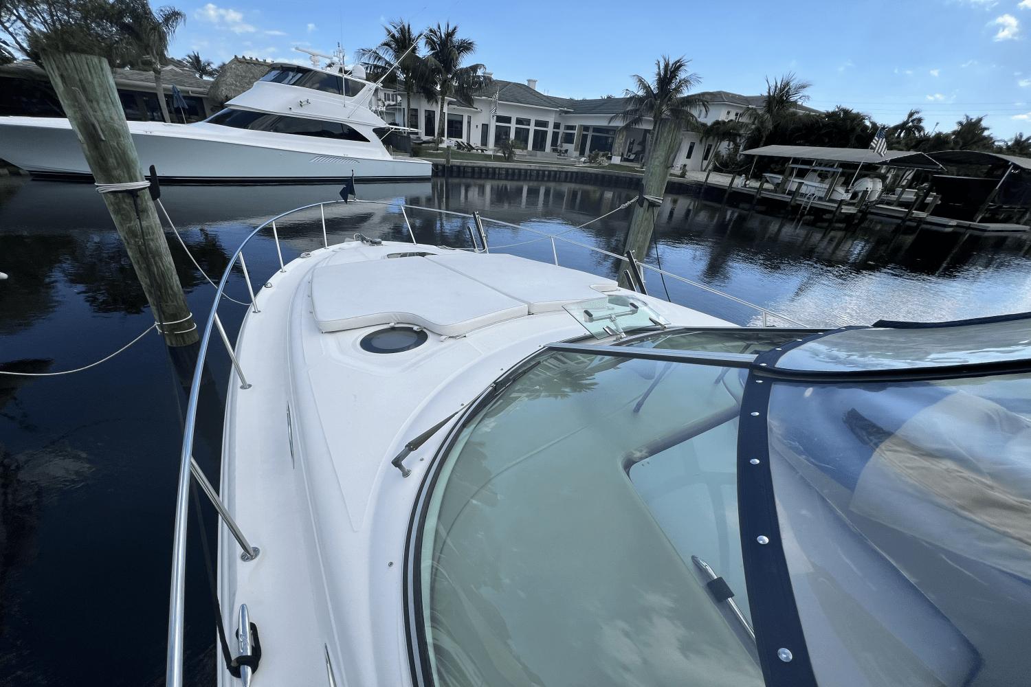 2005 Sea Ray 340 Sundancer yacht docked in a serene marina setting.