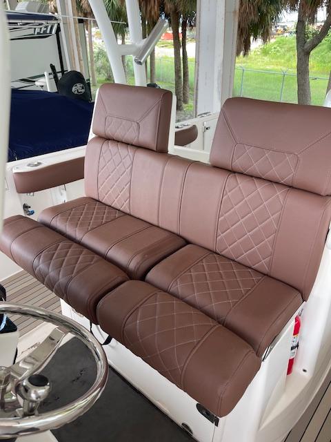 Brown leather seating on 2014 Everglades 325 Center Console boat, featuring diamond stitching.