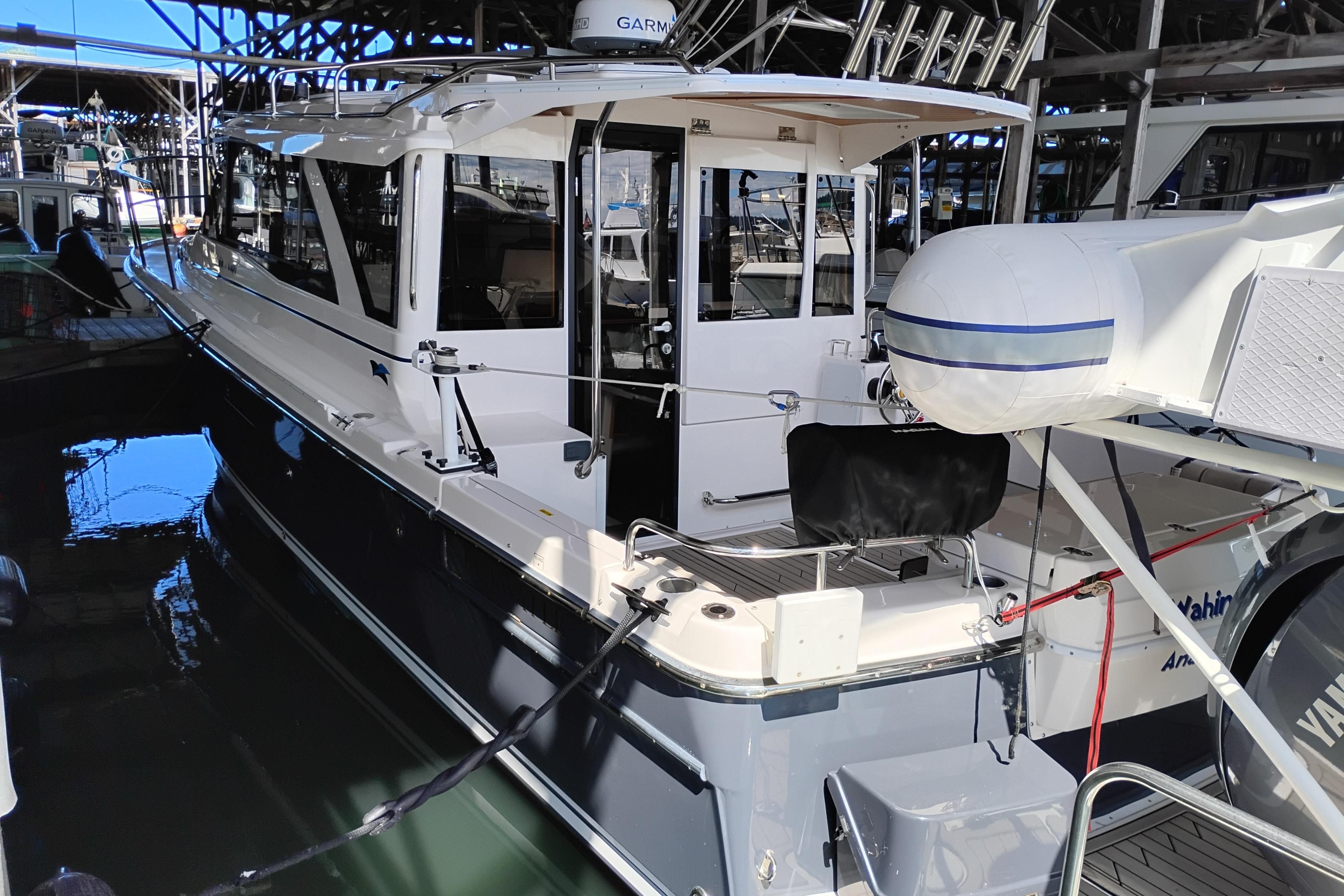 2022 Cutwater C-32 Coupe docked in a marina, showcasing sleek design and modern features.