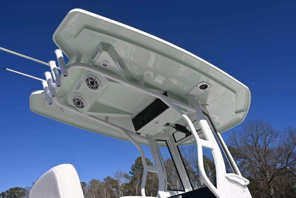 2026 Tidewater 2500 Carolina Bay boat with T-top and rod holders against clear blue sky.