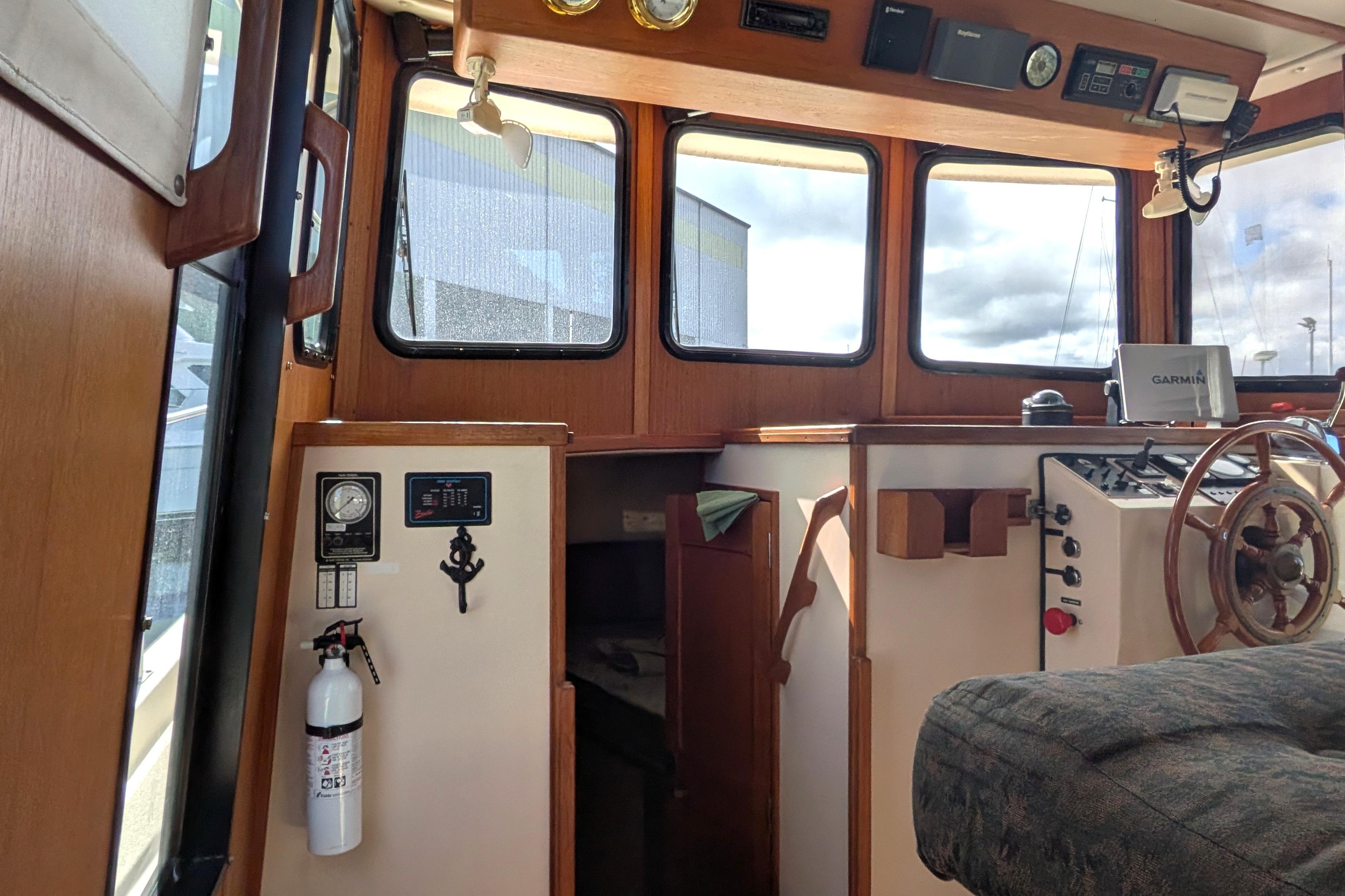 Interior of a 1998 Nordic Tug 32 boat, featuring helm and navigation equipment.
