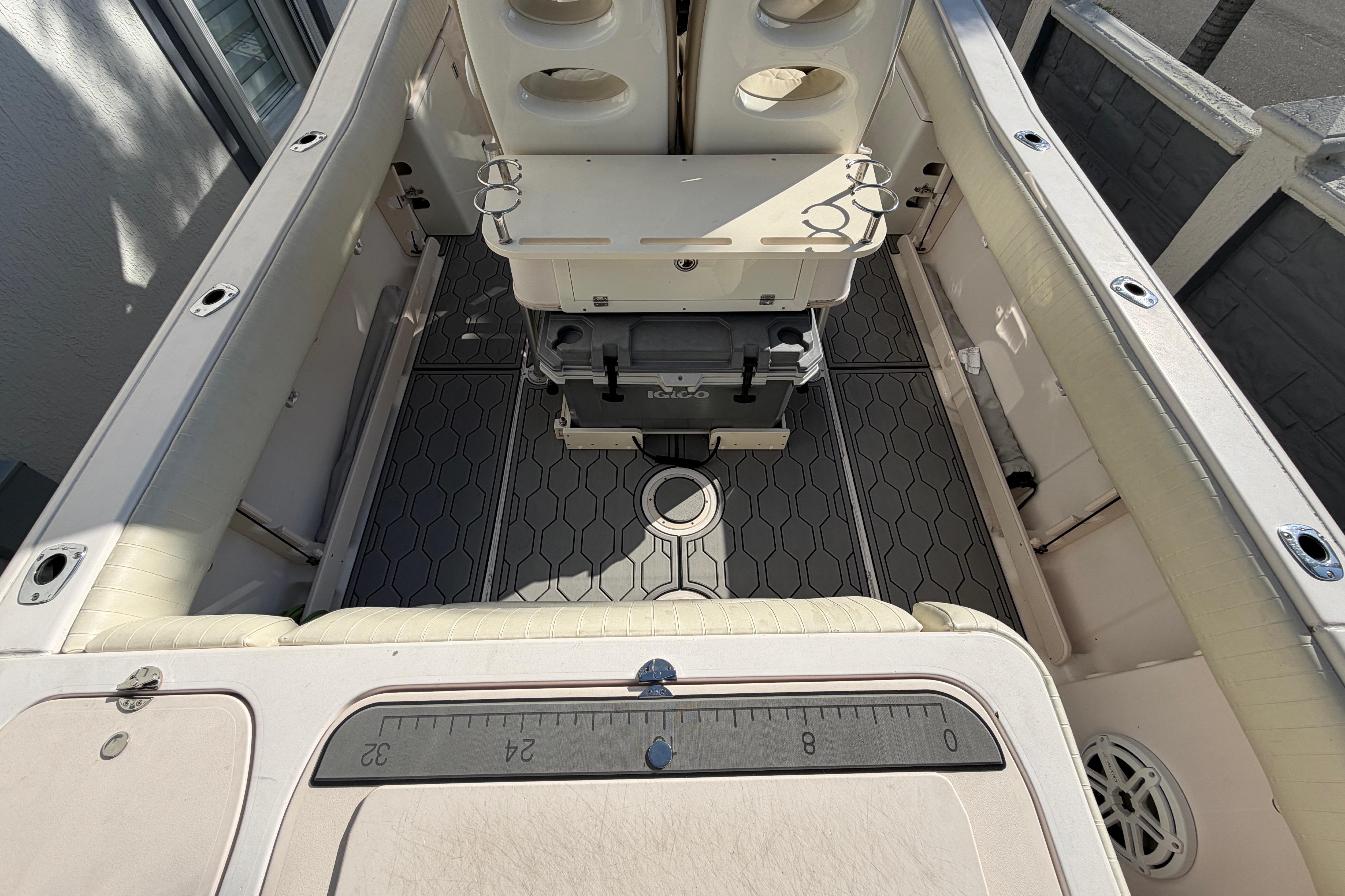 2004 Grady White 273 boat interior with seating, storage, and fishing rod holders.
