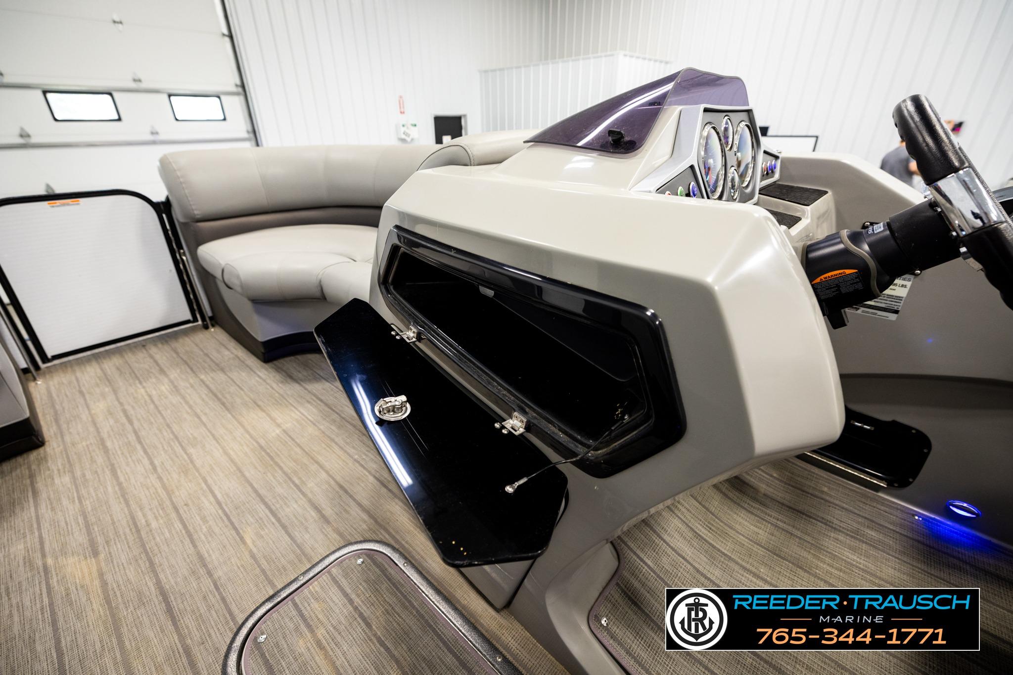 2019 Manitou Oasis SR VP boat interior with steering console and seating area.