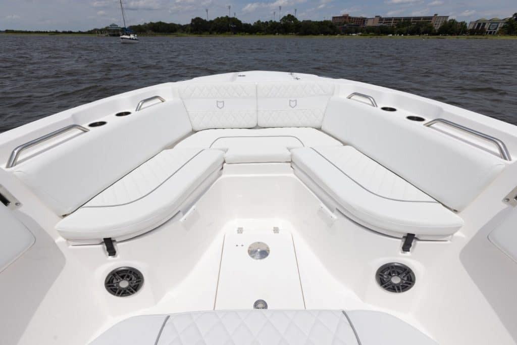 2027 Sea Fox 268 Commander boat interior with white cushioned seating and cup holders.