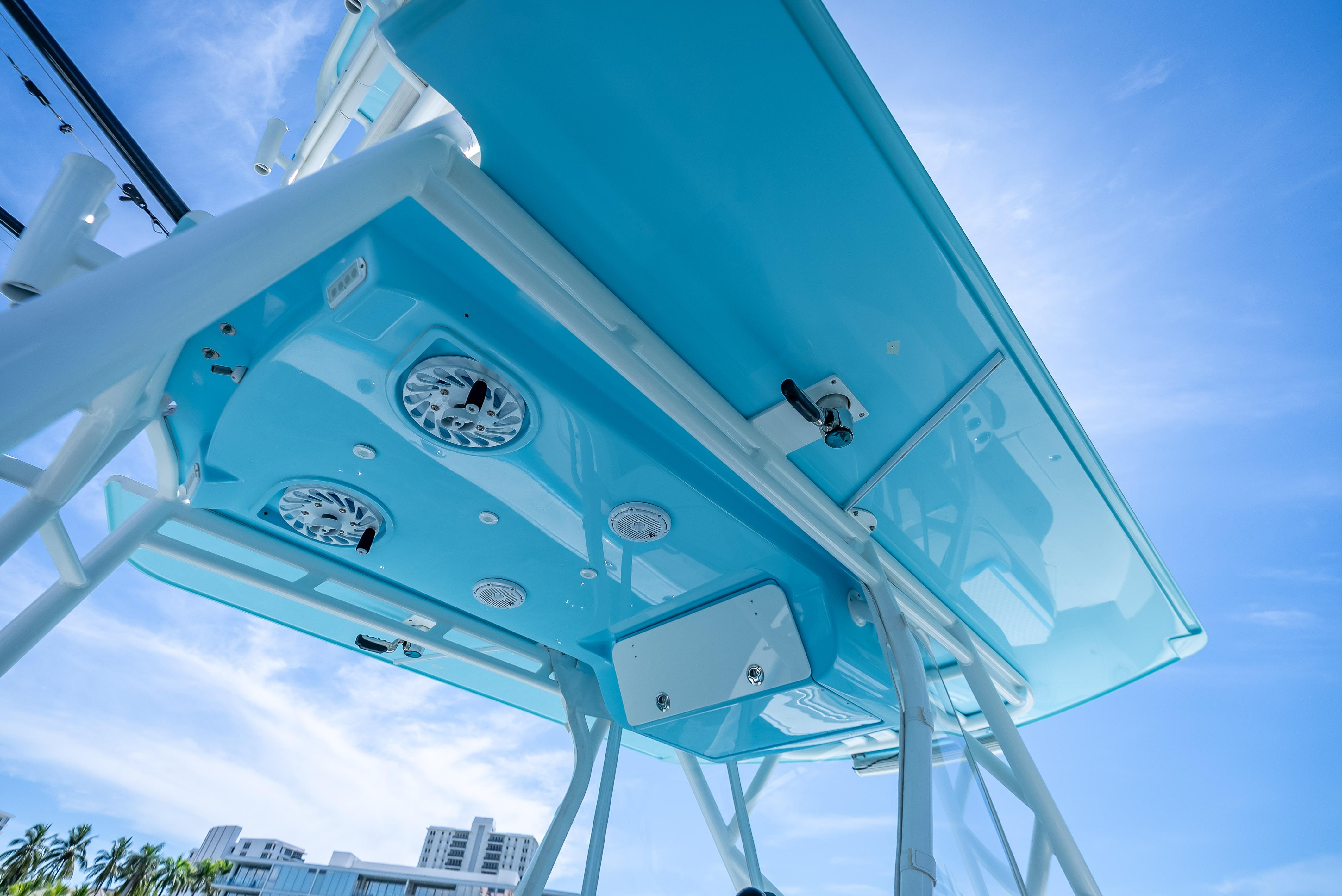 2016 Yellowfin 39 Offshore boat canopy with speakers, under a clear blue sky.