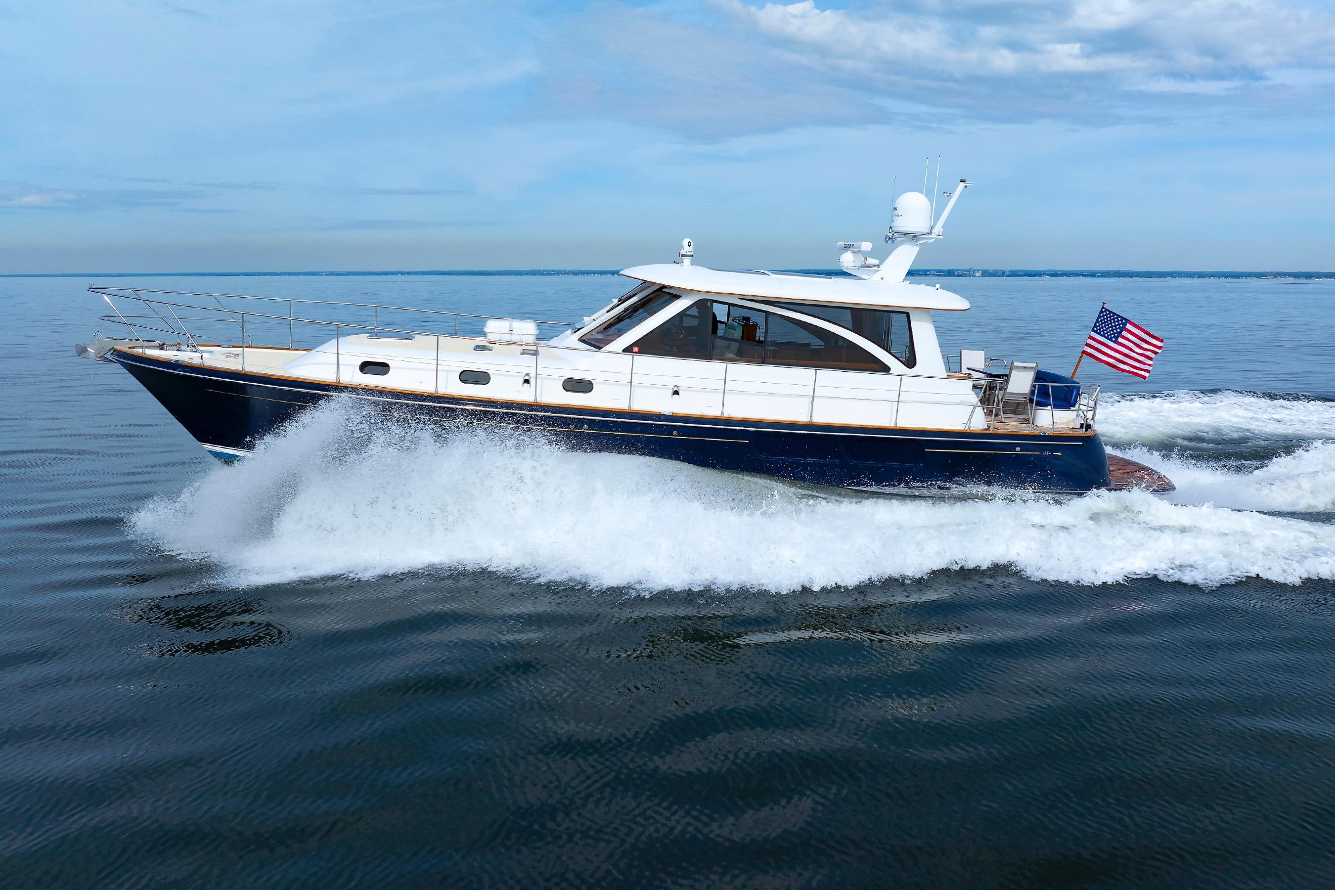 2009 Hunt Yachts 52 Express cruising on open water with American flag.