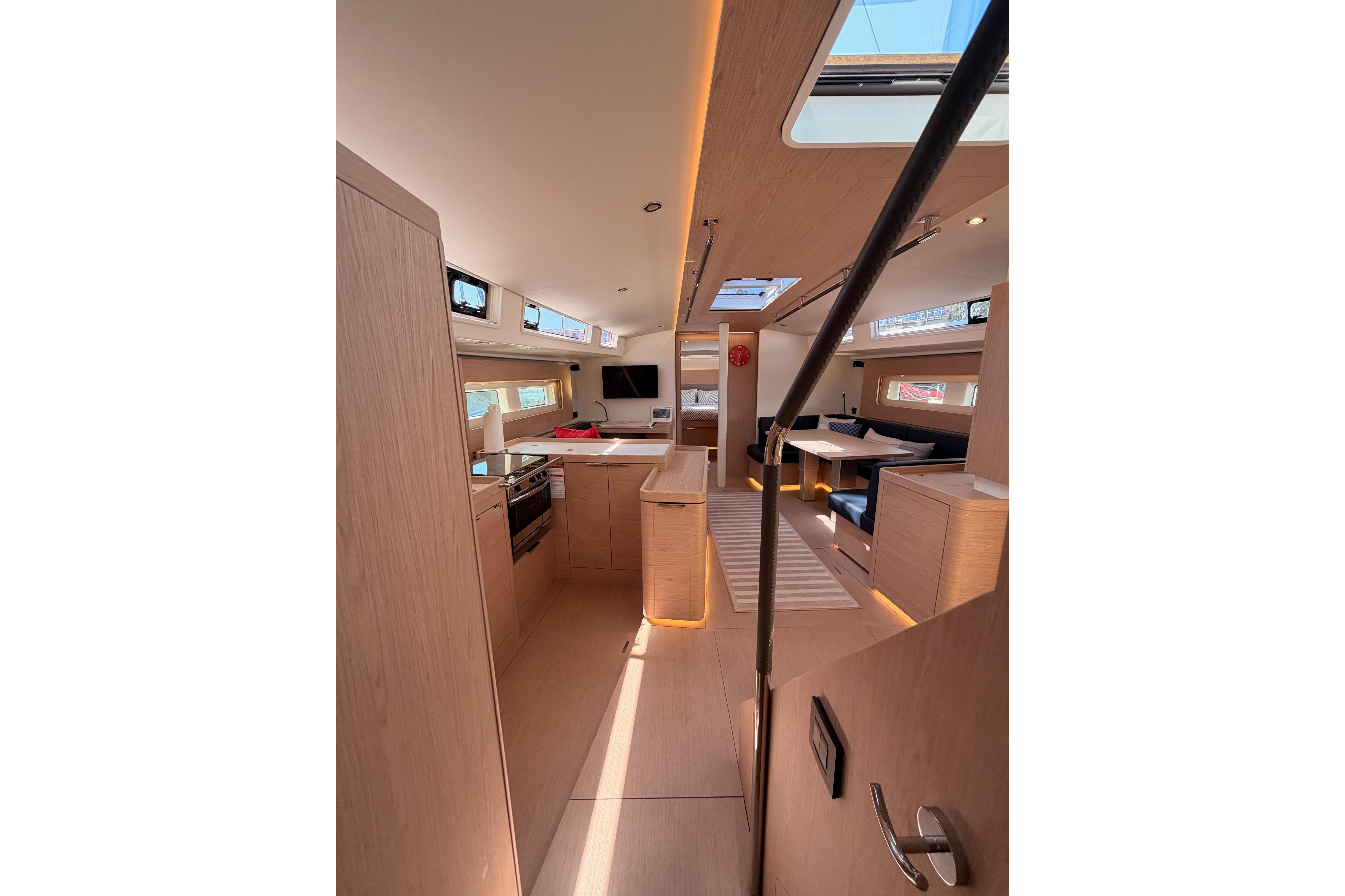 Luxurious interior of 2022 Beneteau Oceanis Yacht 54, featuring modern kitchen and seating area.