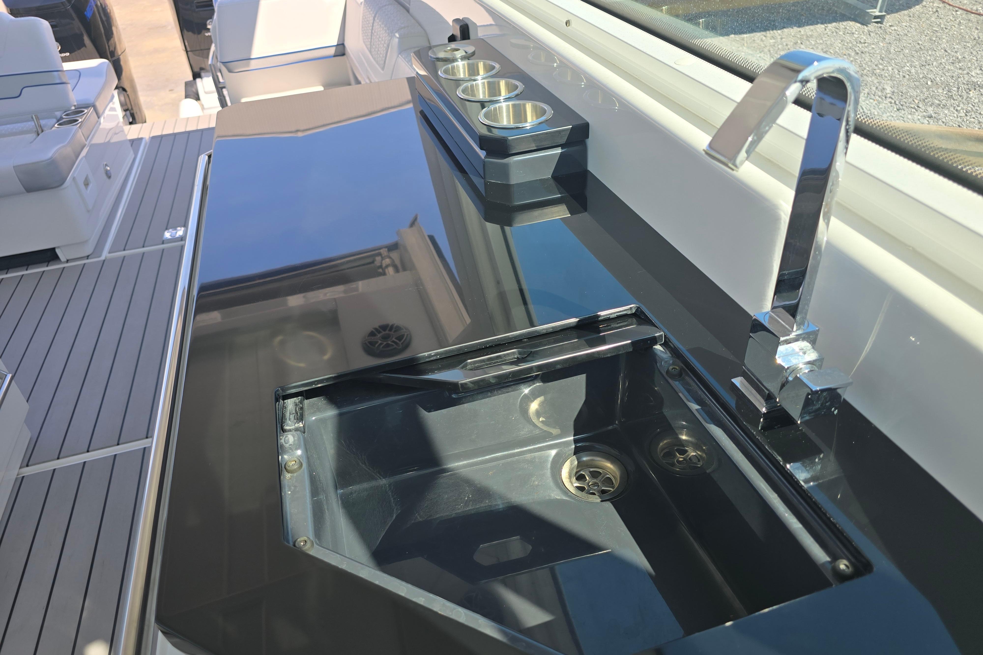 Luxury deck area of 2025 Formula 380 Super Sport Crossover OB with sleek sink and faucet.