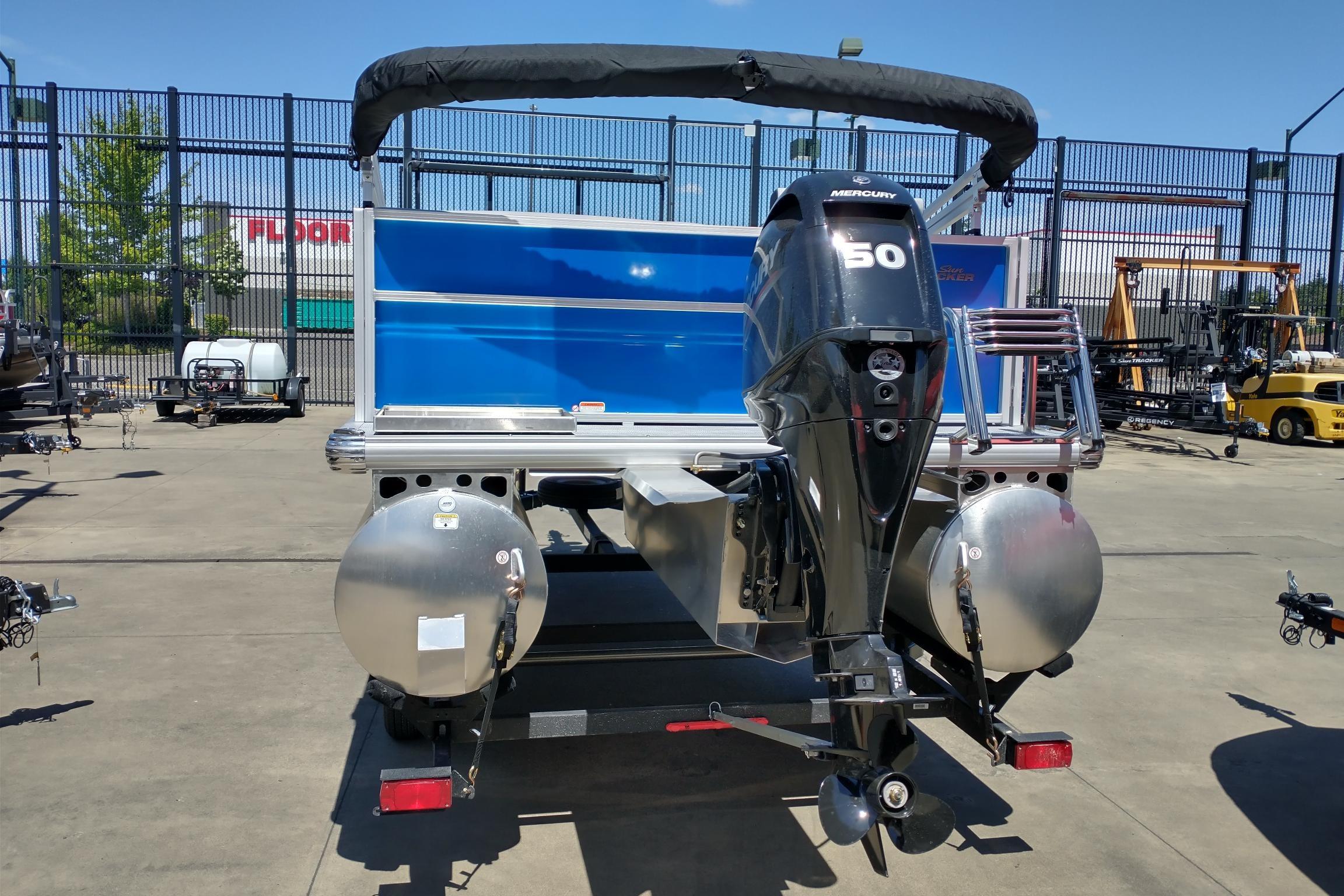 2026 Sun Tracker Party Barge 16 DLX with Mercury 50 engine, parked outdoors.