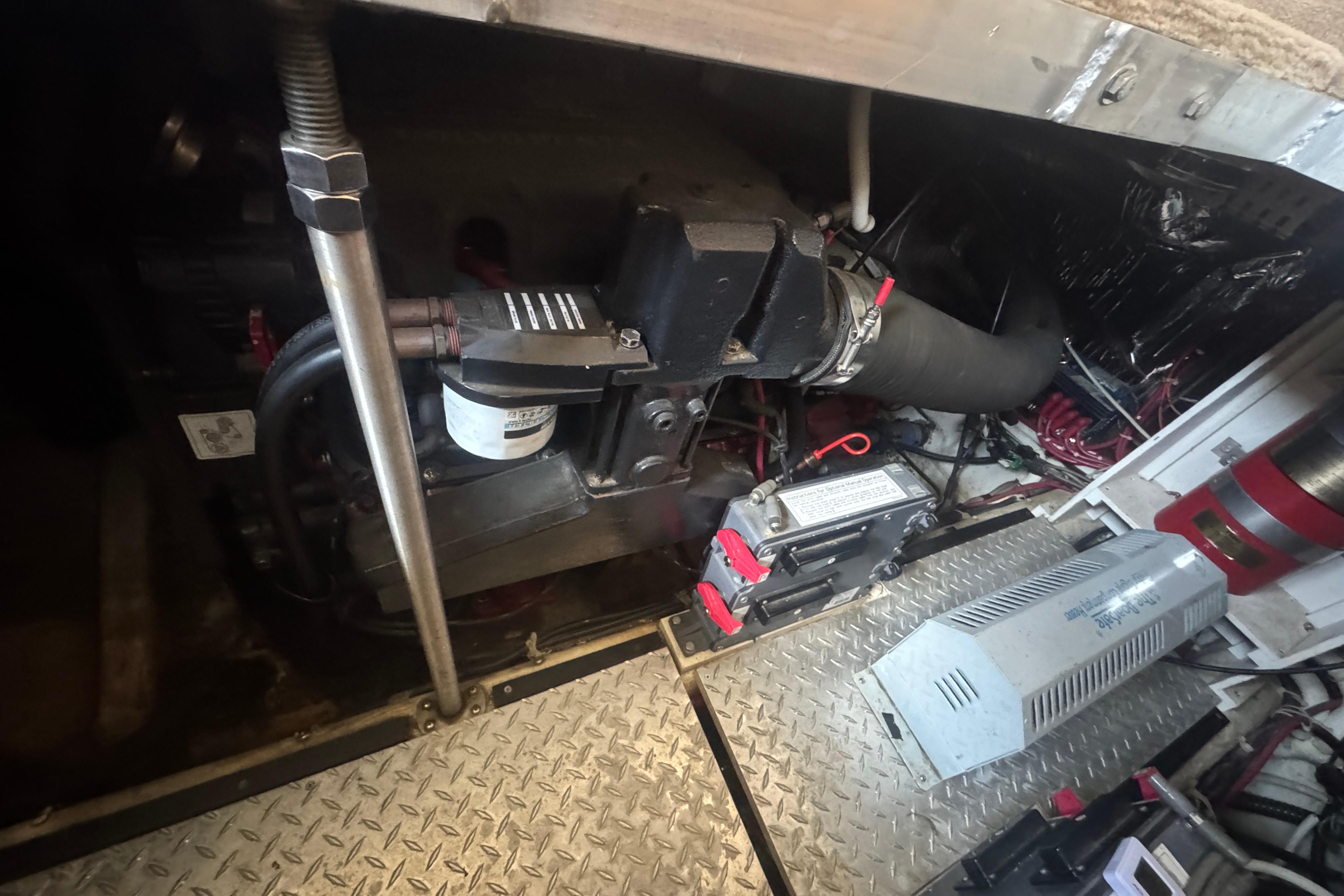 Engine room of a 2002 Carver 396 Motor Yacht, showcasing mechanical components and wiring.
