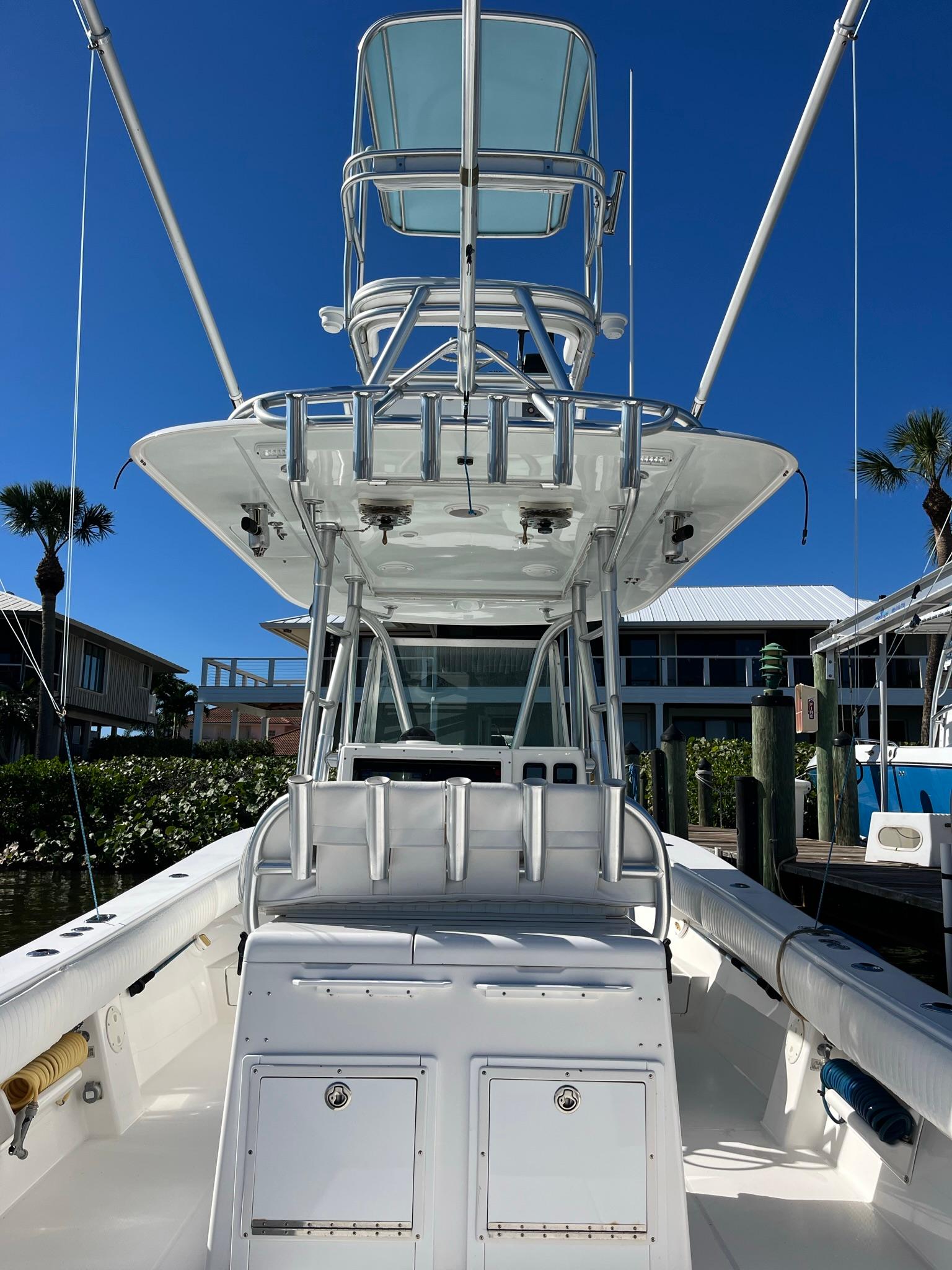 2006 Regulator 32 Center Console boat docked under clear sky.