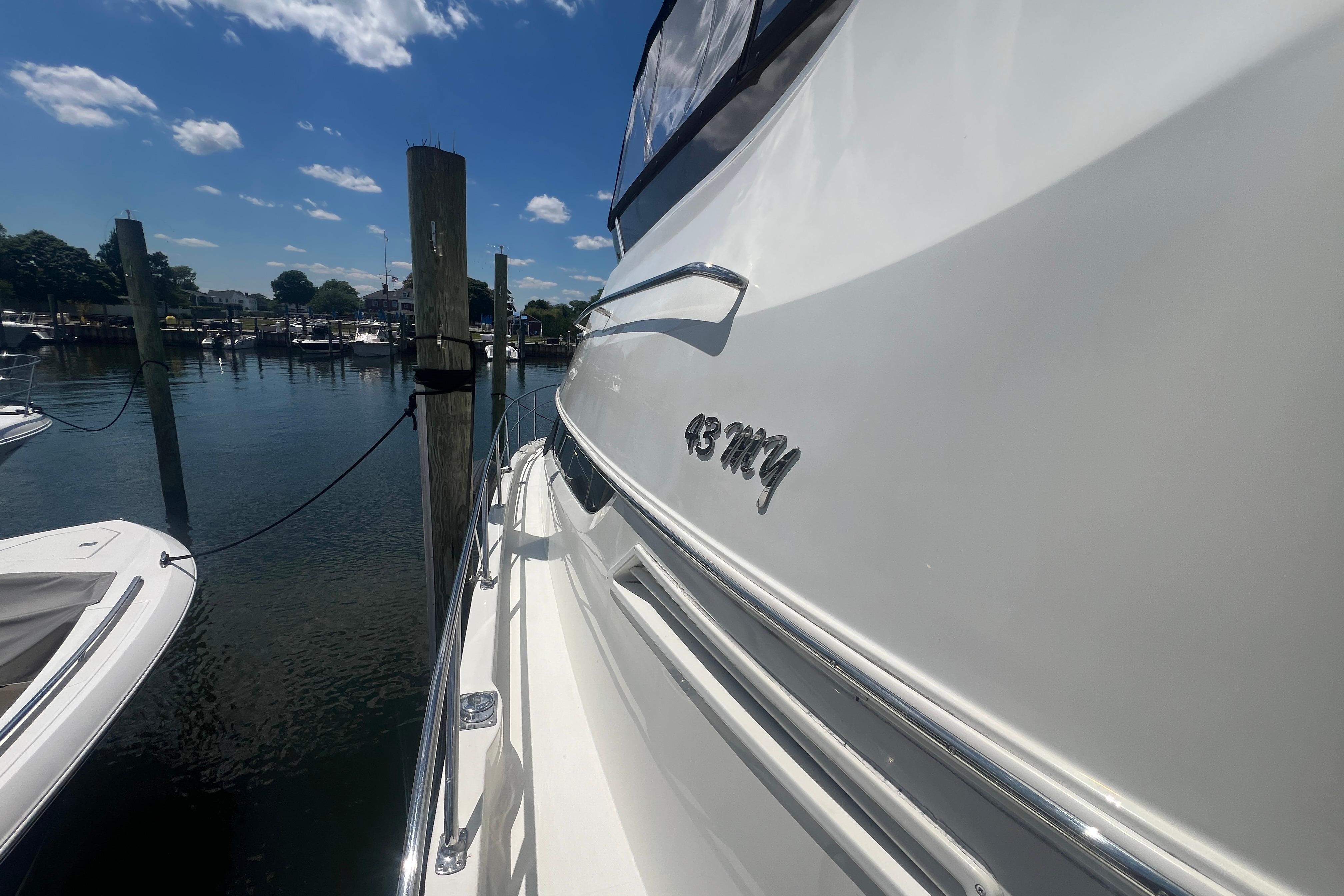 2006 Carver 43 Motor Yacht docked at marina under blue sky.