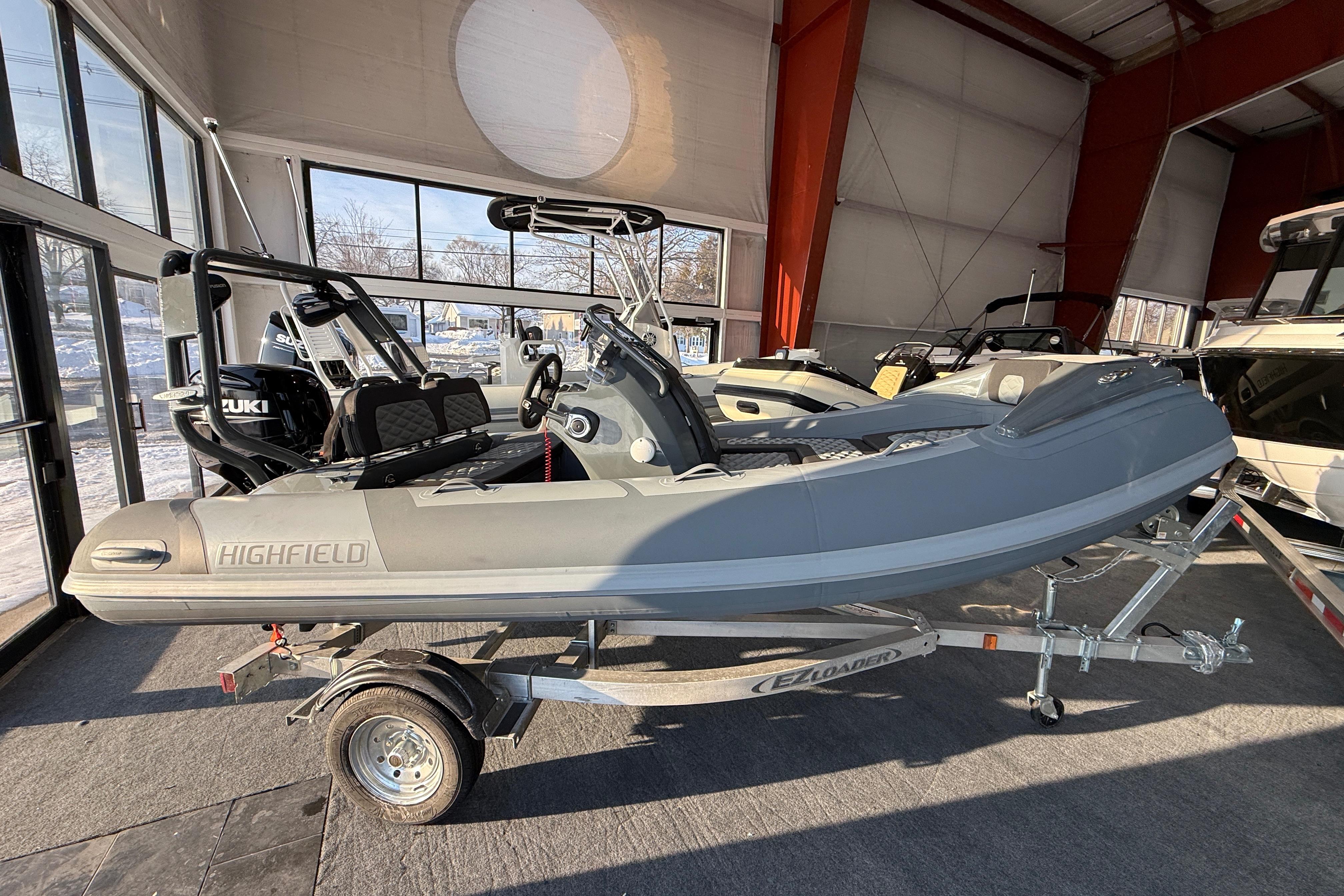 2026 Highfield Sport 390 boat on trailer in showroom.